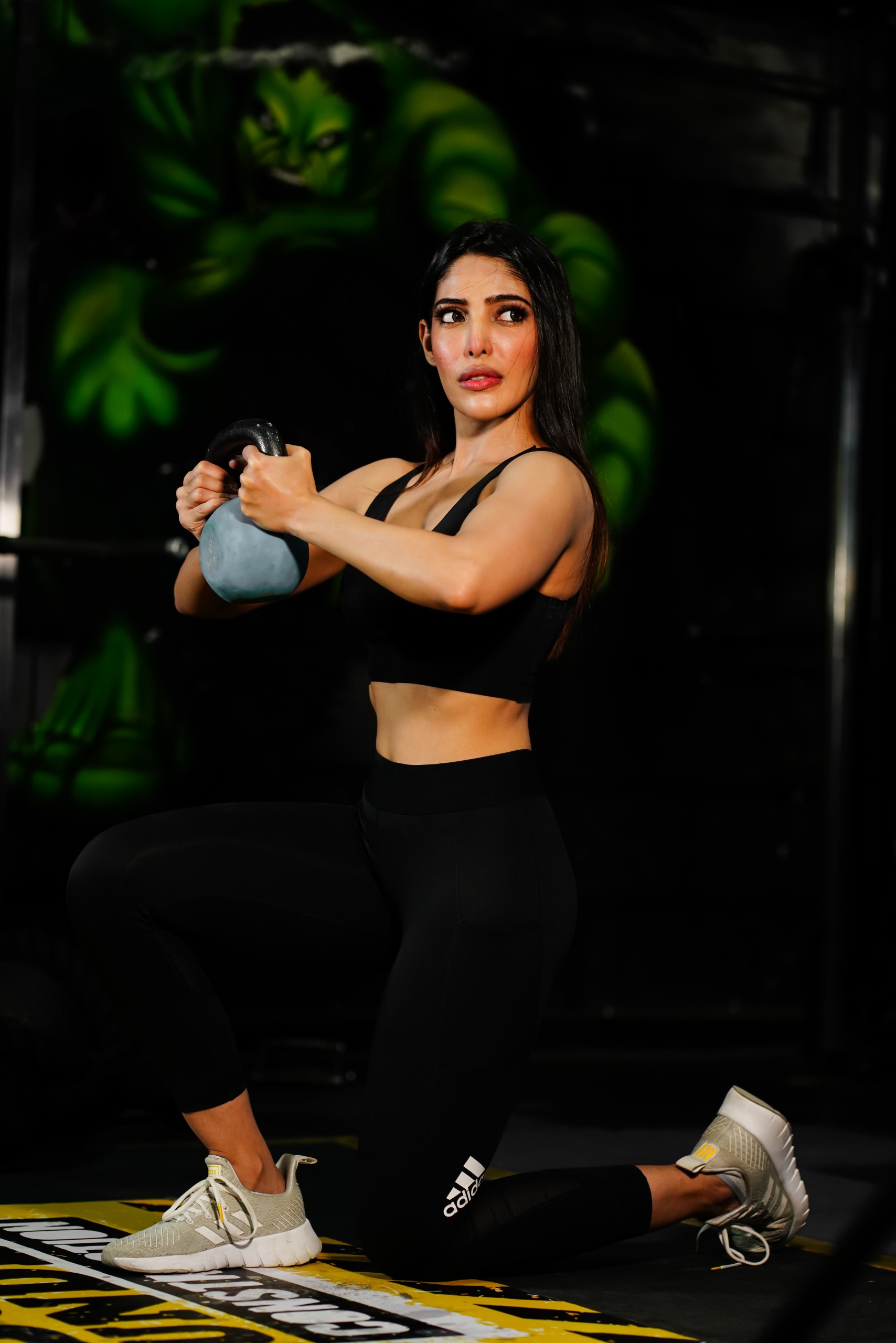Female working out in gym with Kettlebell