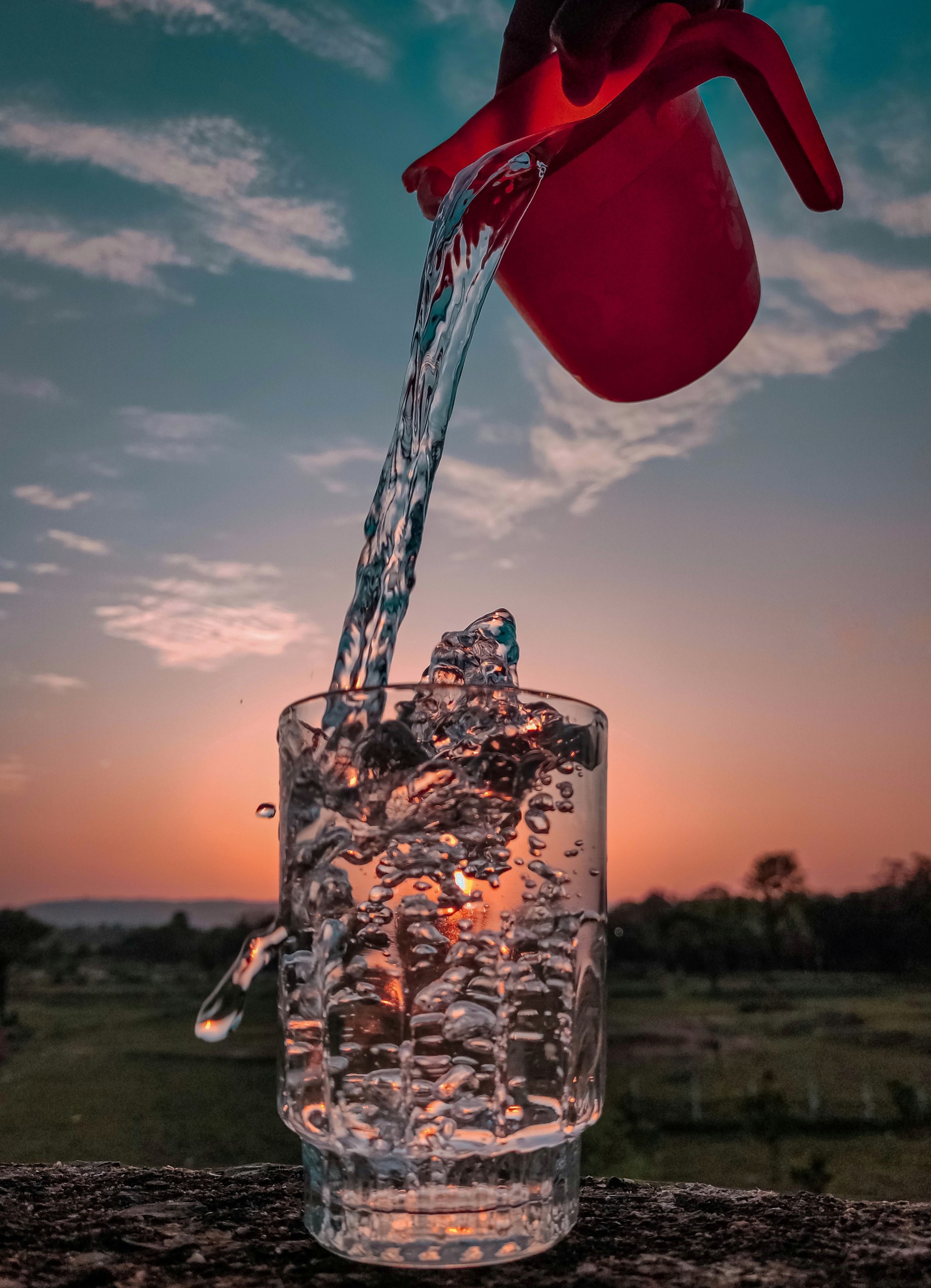 Glass of water and sunset