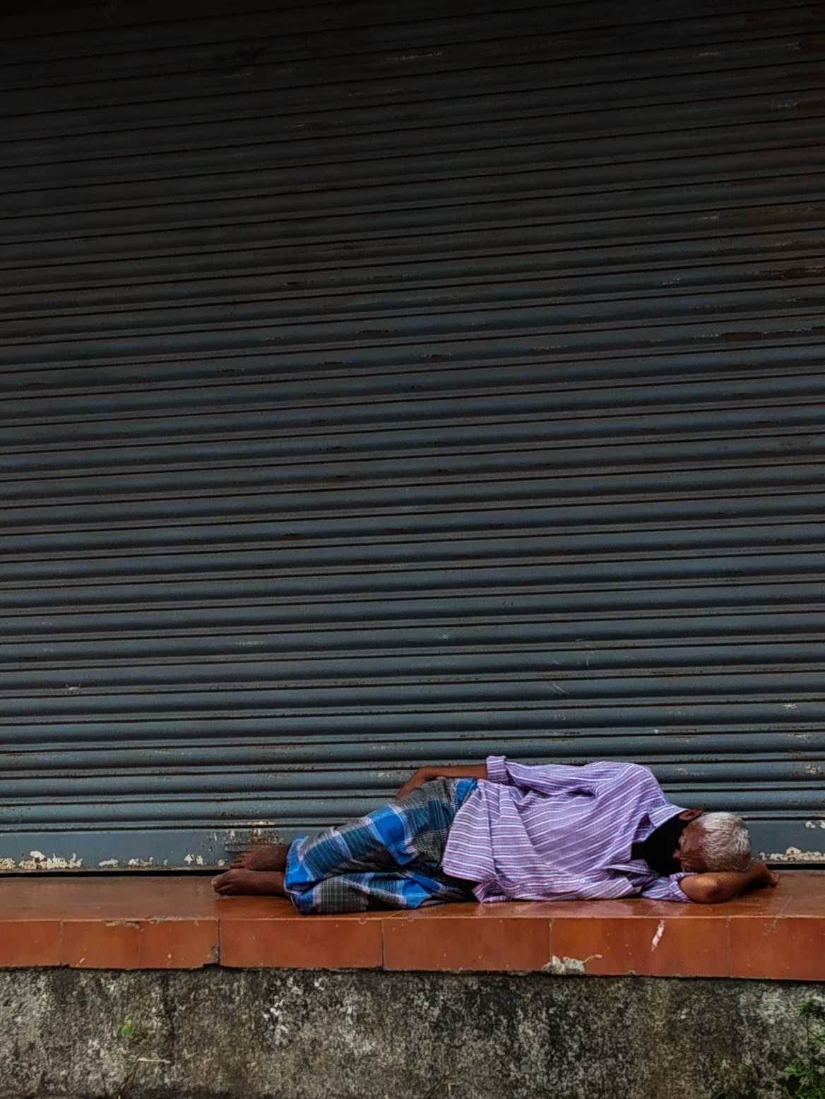 Homeless Man Lying on the Street