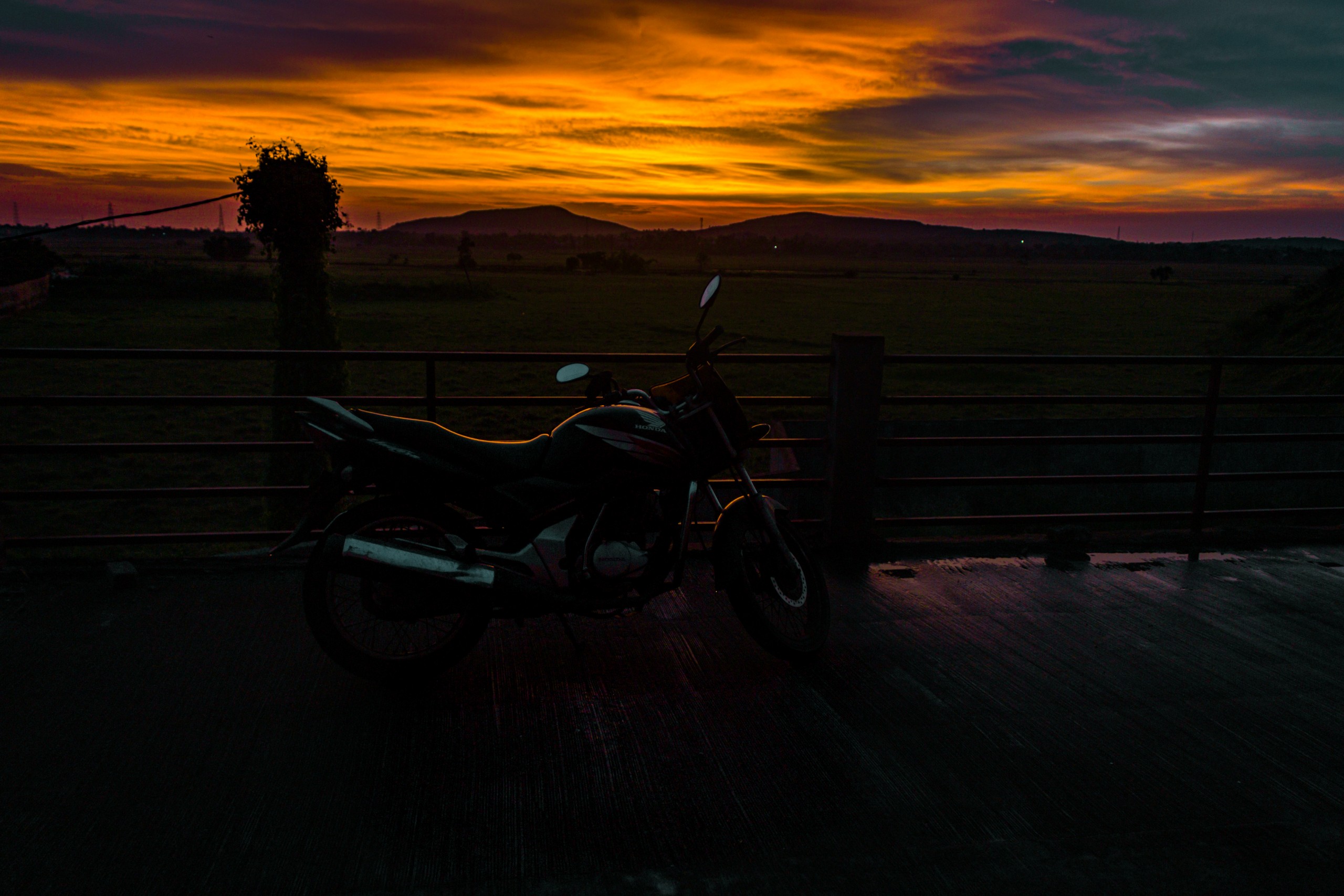 Motorcycle parked during sunset 