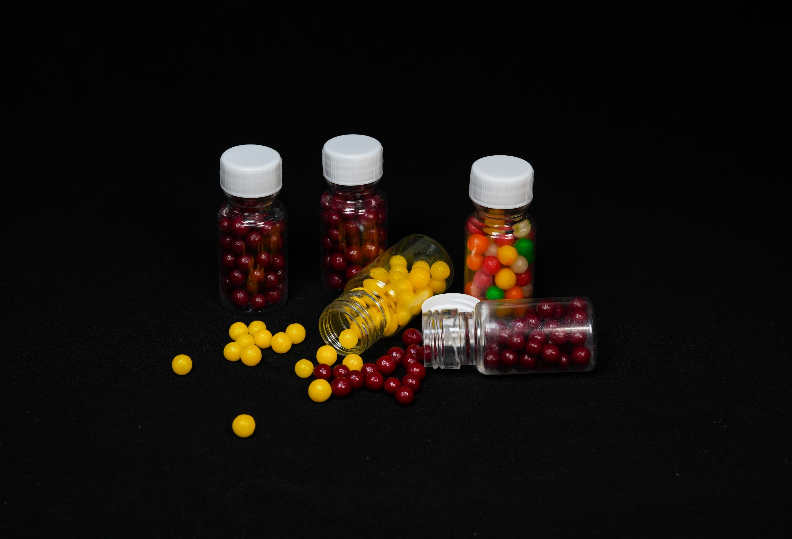Small bottle full of colorful drops candy