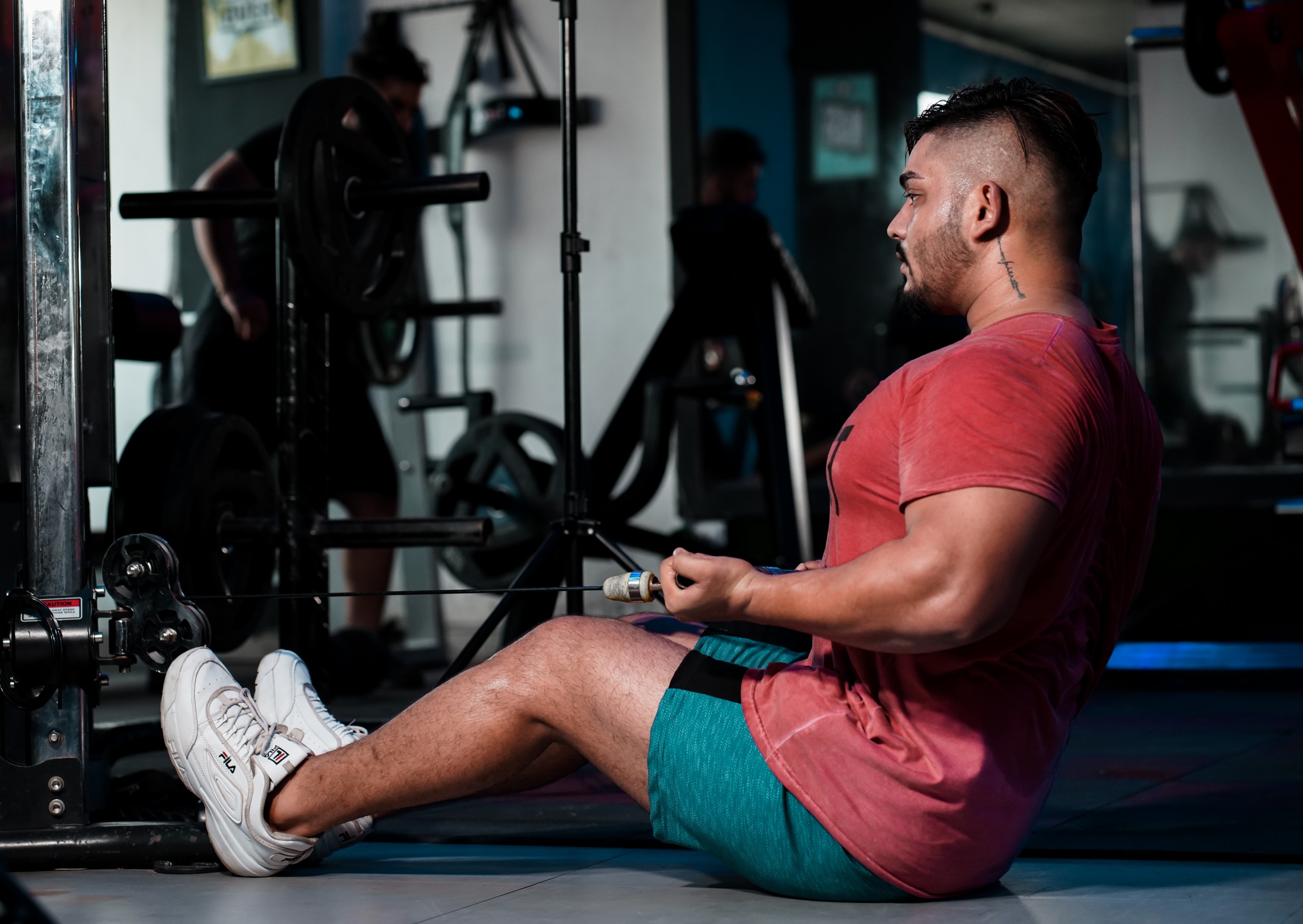 Strong muscles man pulling weights with arms in gym