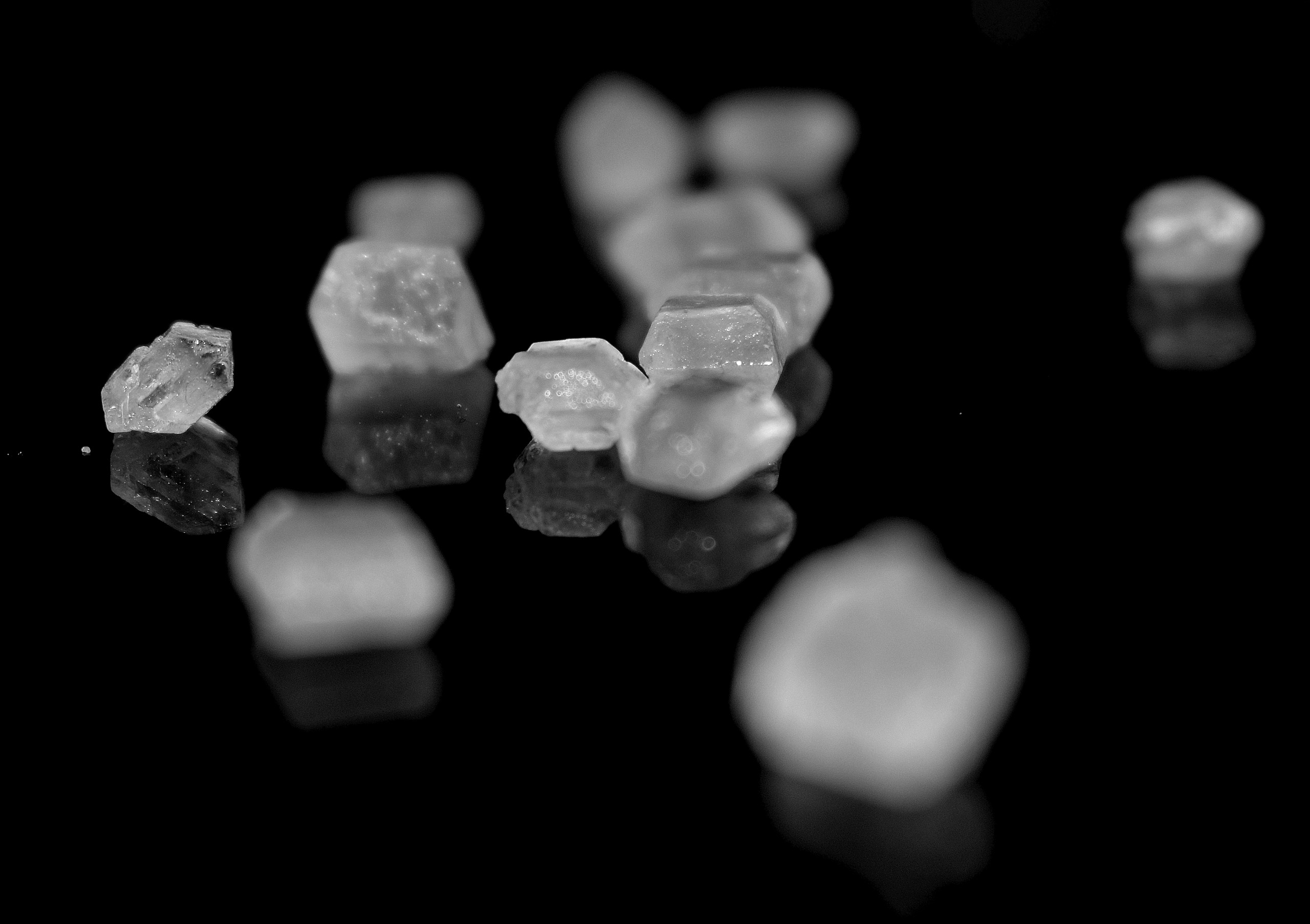 White Mineral Crystal on black surface