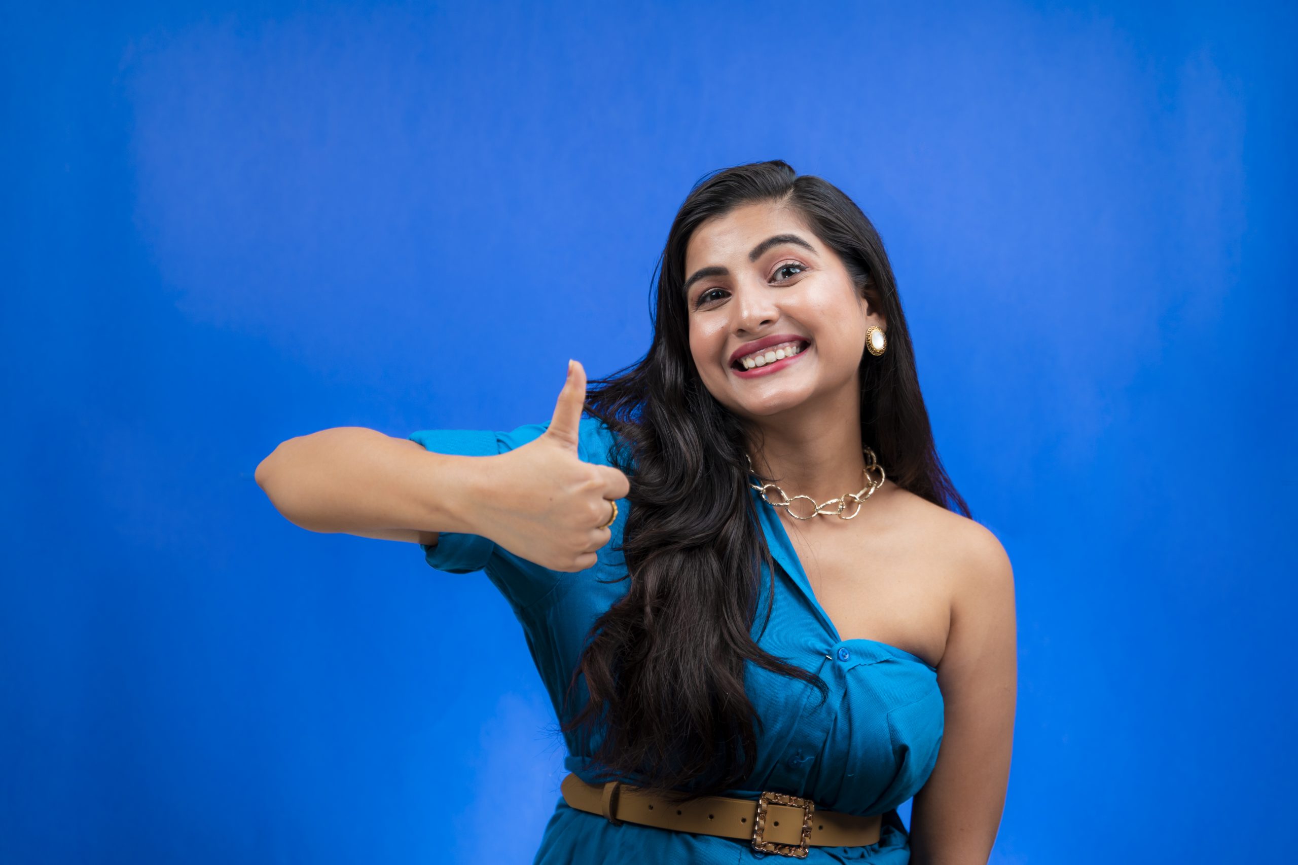 Young Cheerful Woman Smiling and Showing Thumbs Up