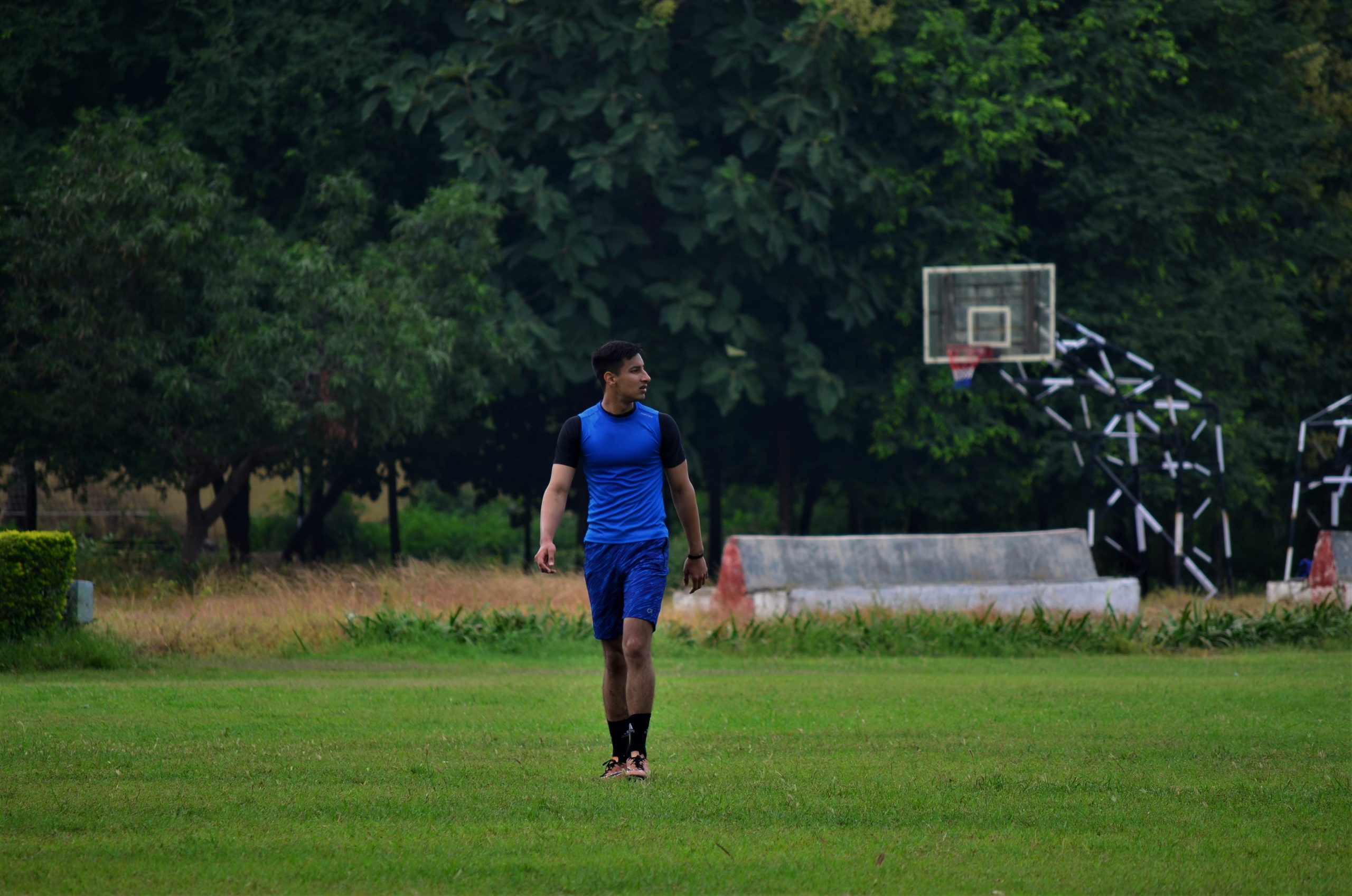 A basketball player walking across the field