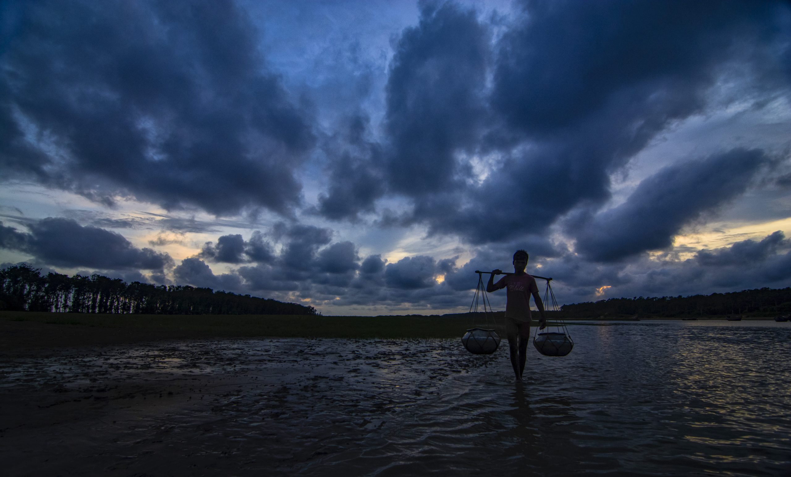 A fisher walking on Talsari Beach