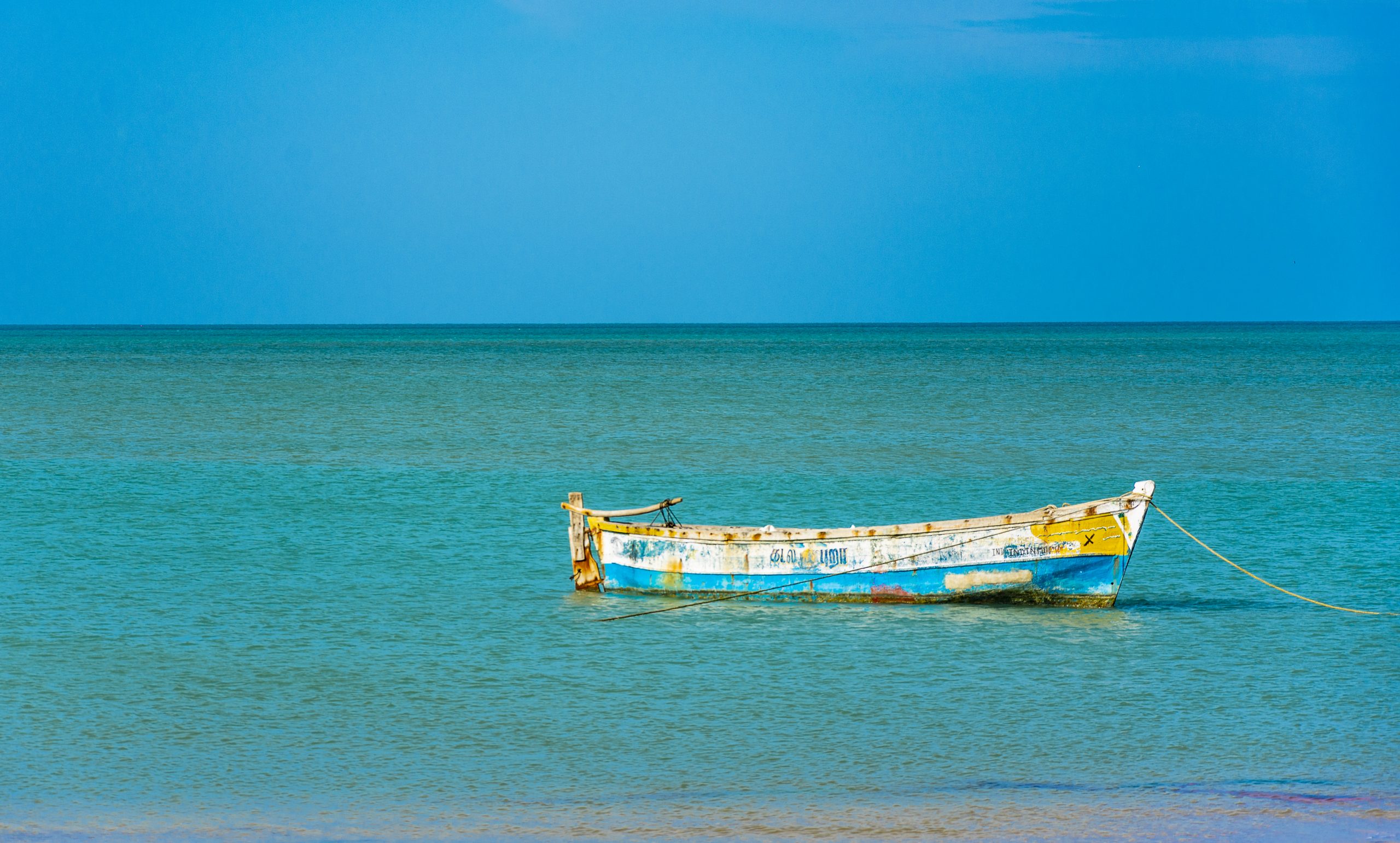 A fishing boat anchored to the shore
