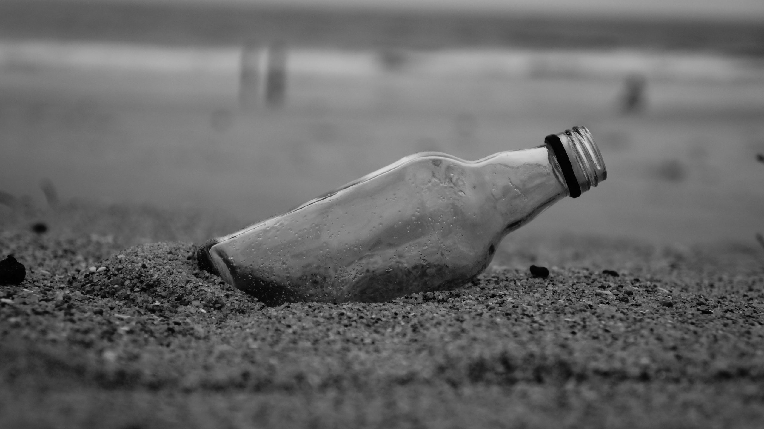 A glass bottle on beach sand