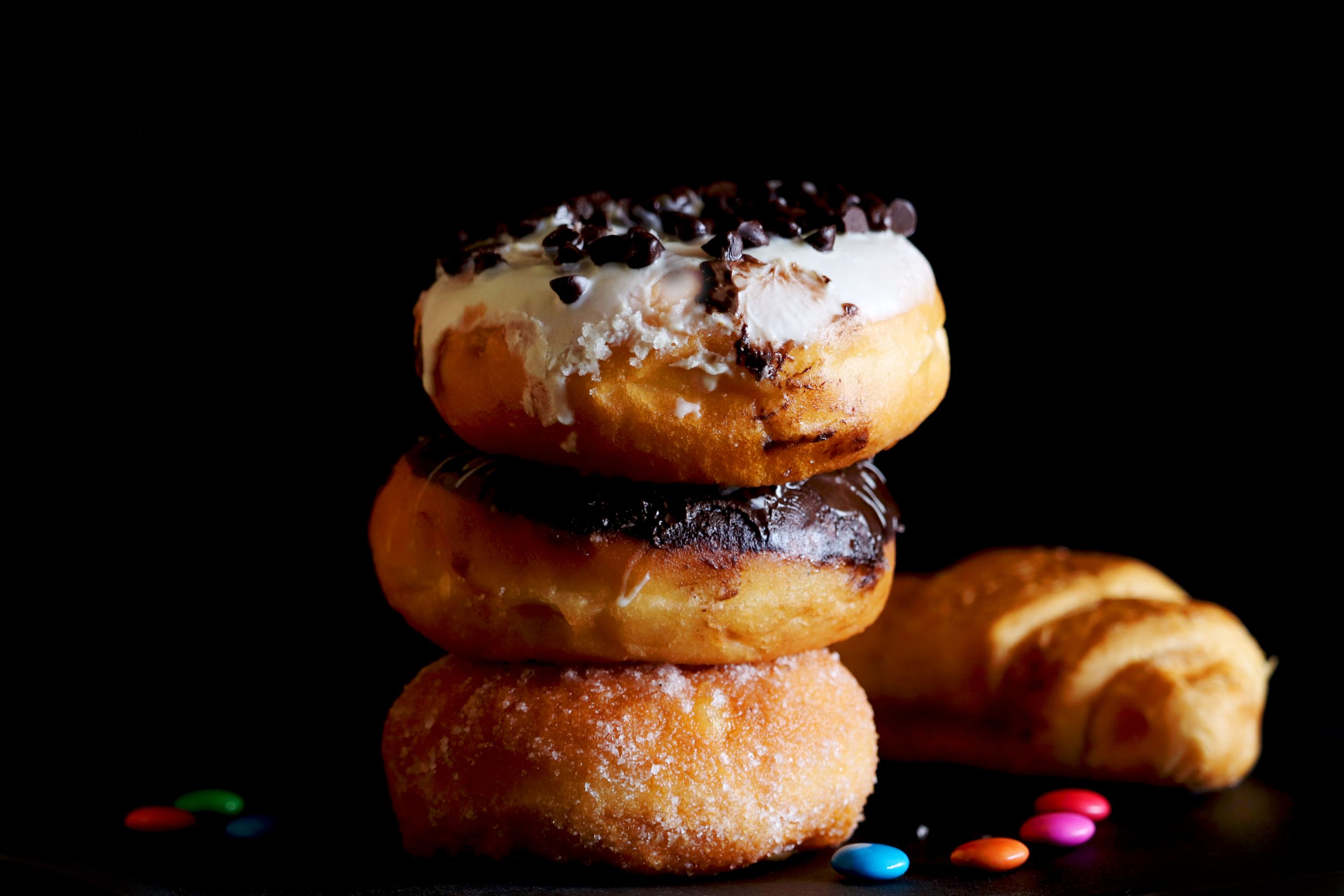 A pile of Donuts on Black Background