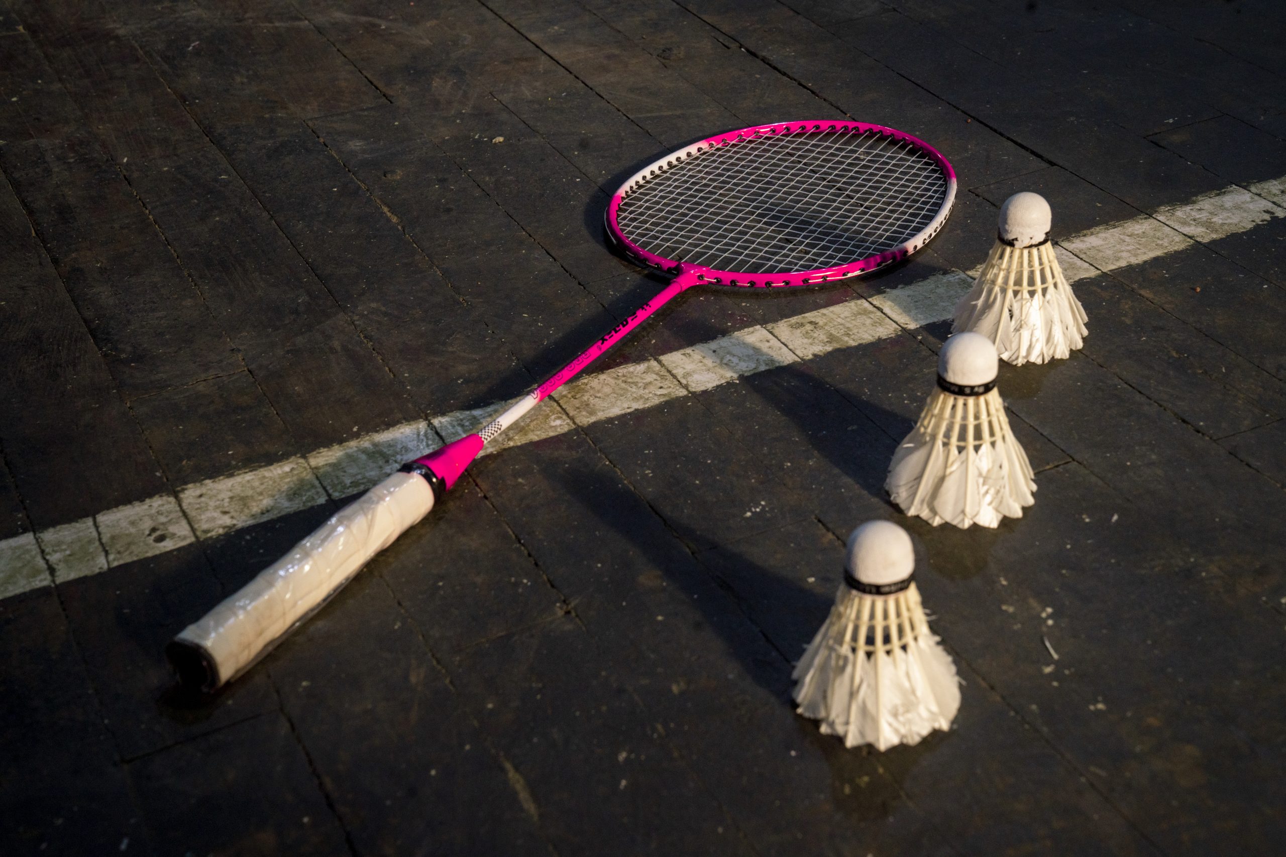 Badminton racket and shuttlecock on the ground