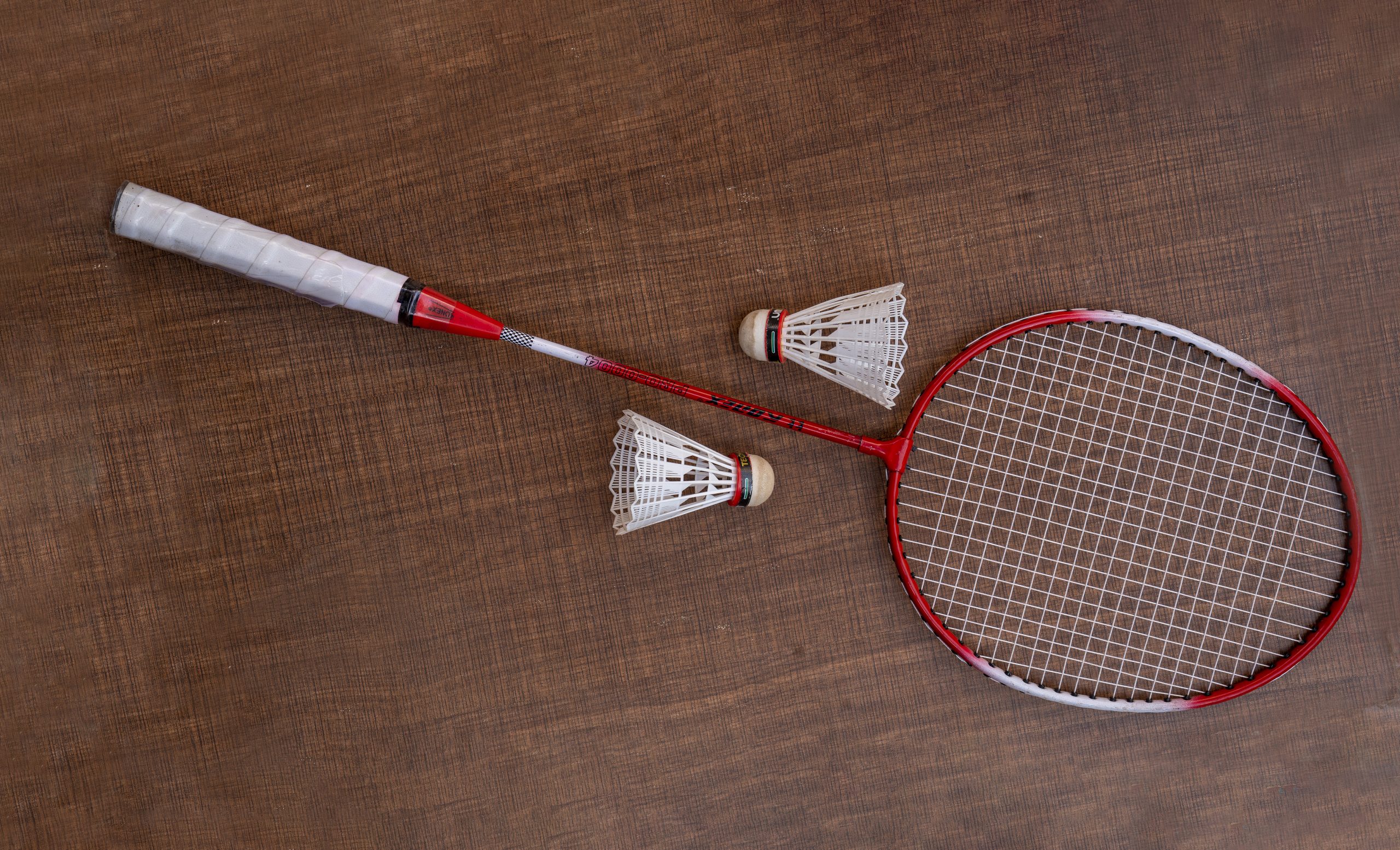 Badminton racket and two shuttlecocks