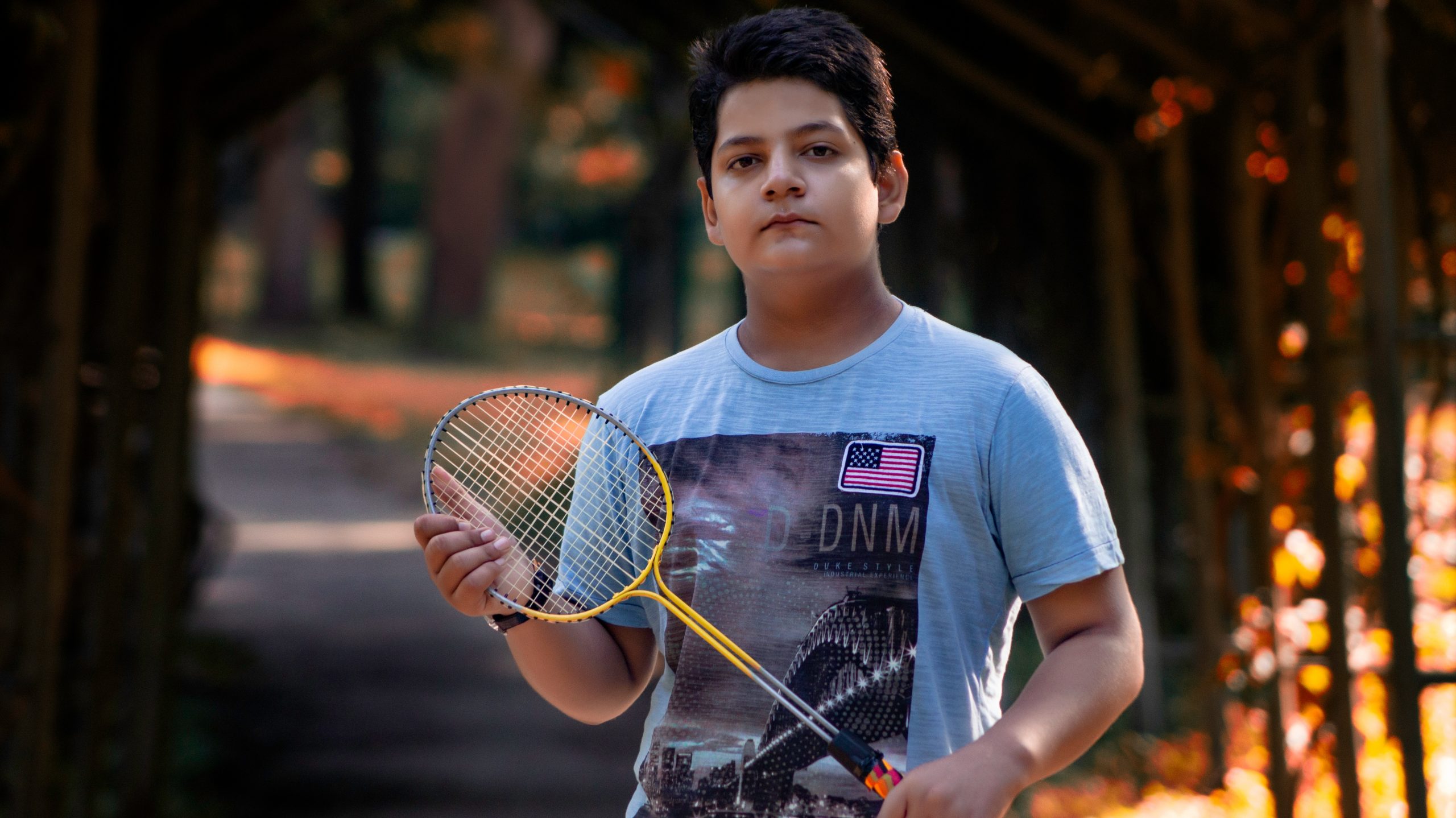Boy holding badminton rocket