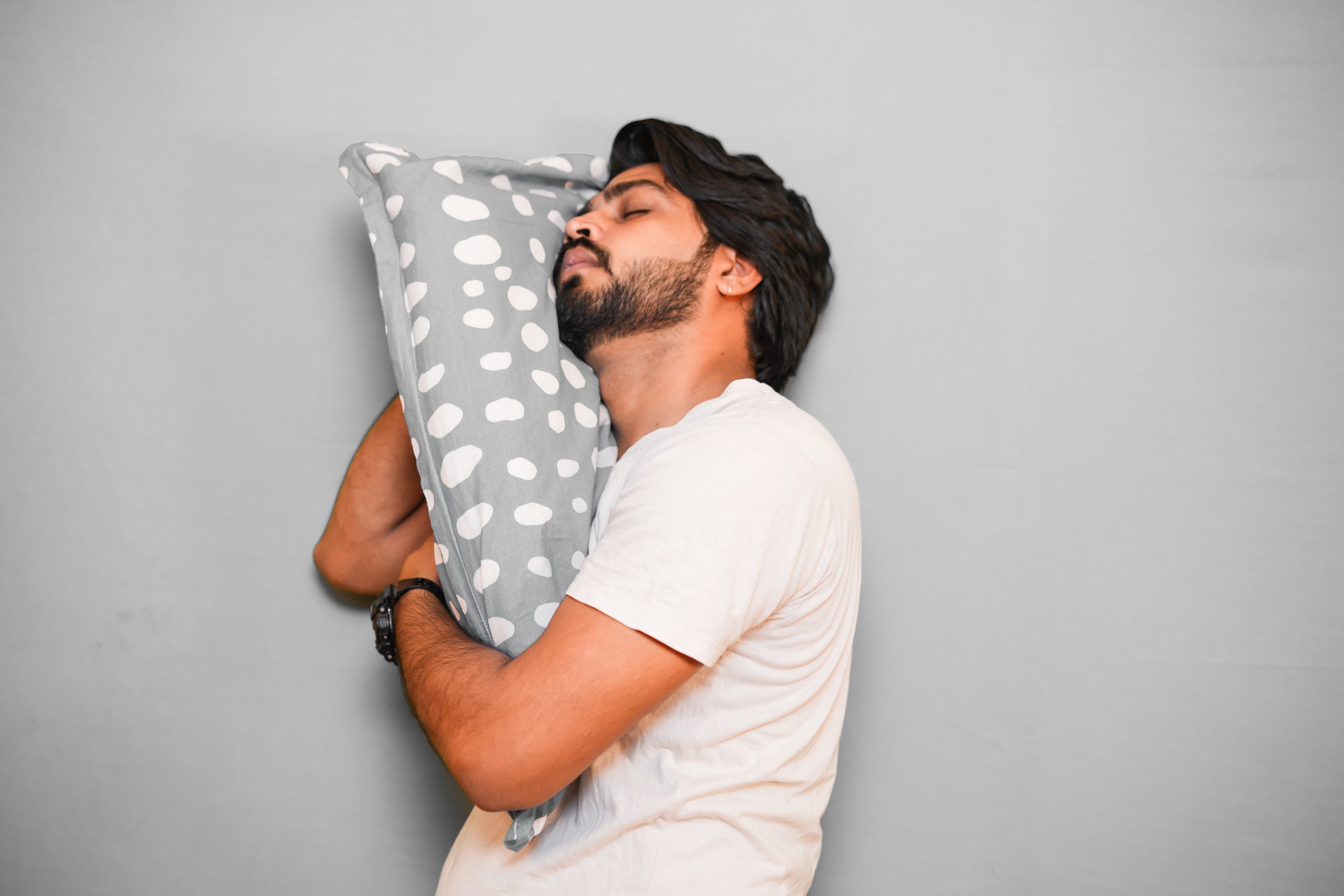 Boy leaning in grey pillow