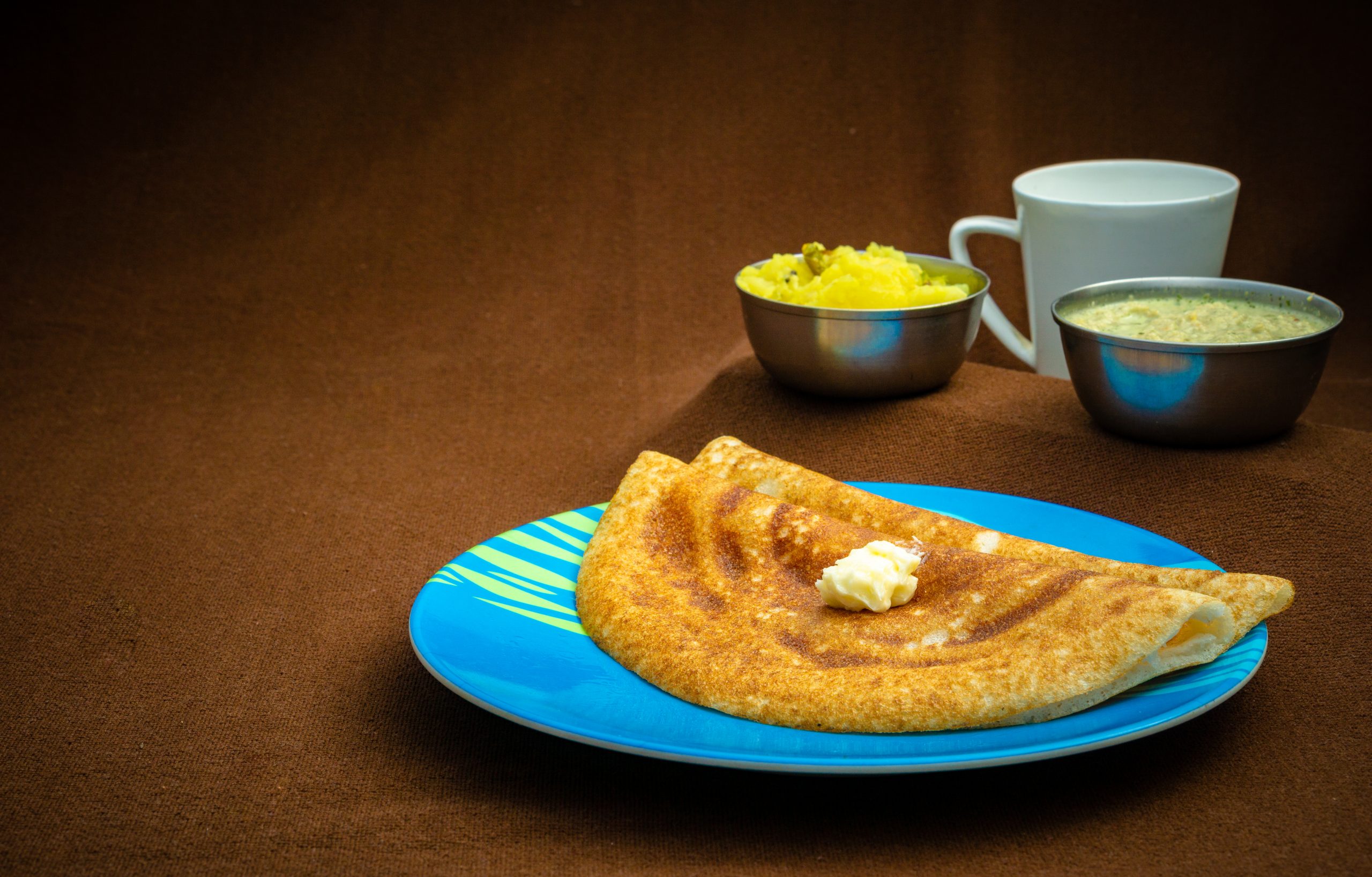 Butter Dosa and Some Dish on the Table