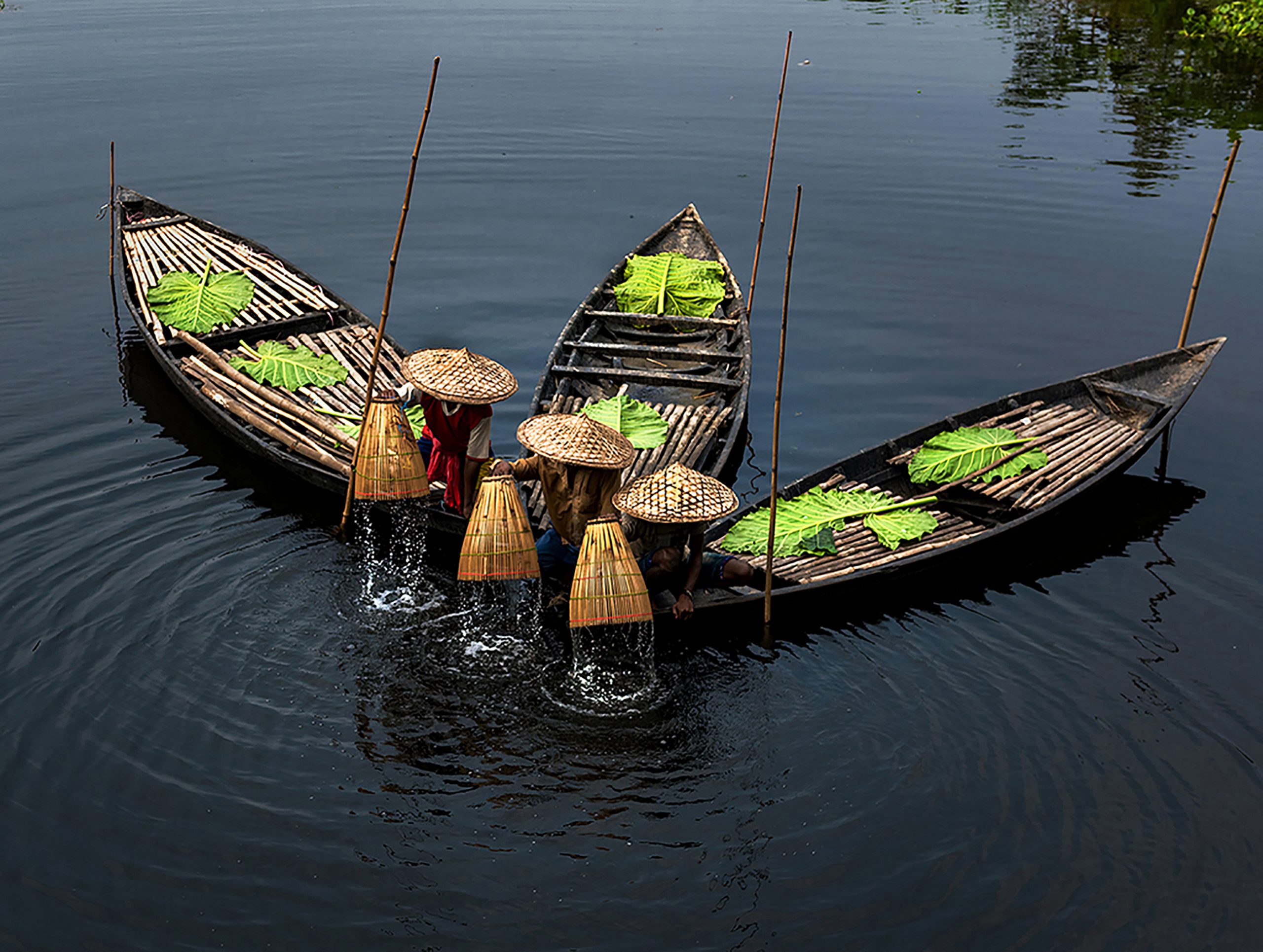 Fishermen washing their wooden basket