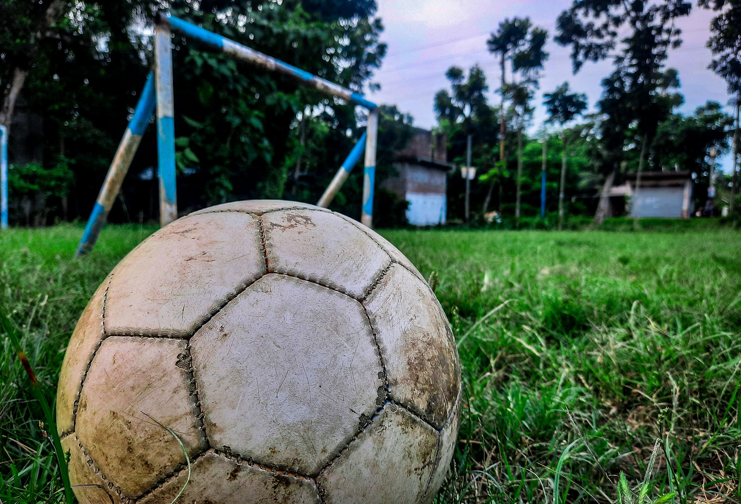 Football beside goalpost