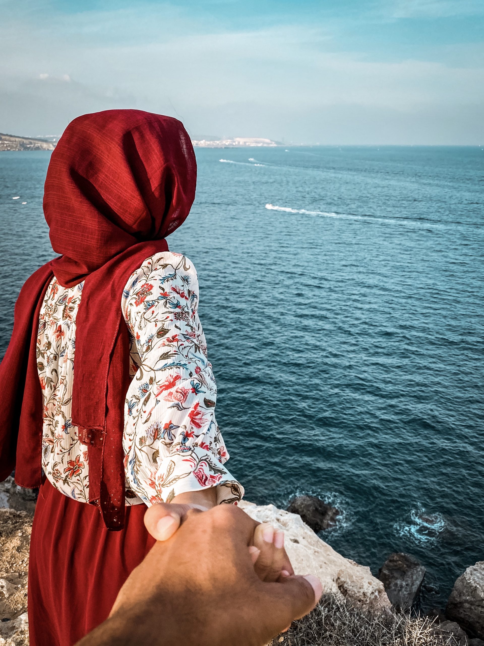 Girl Holding her Partner Against the Sea on a Cliff