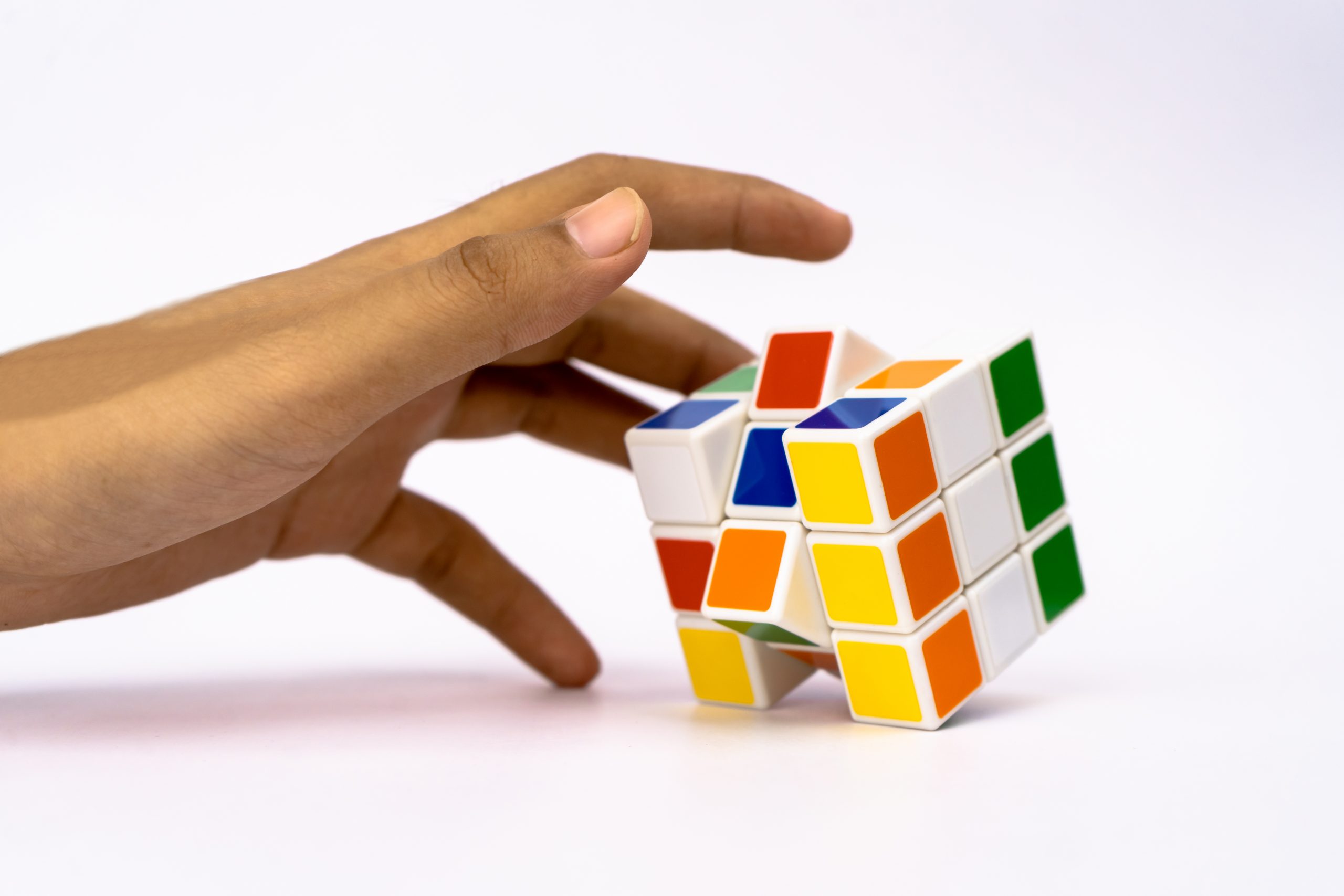 Hand reaching for cube