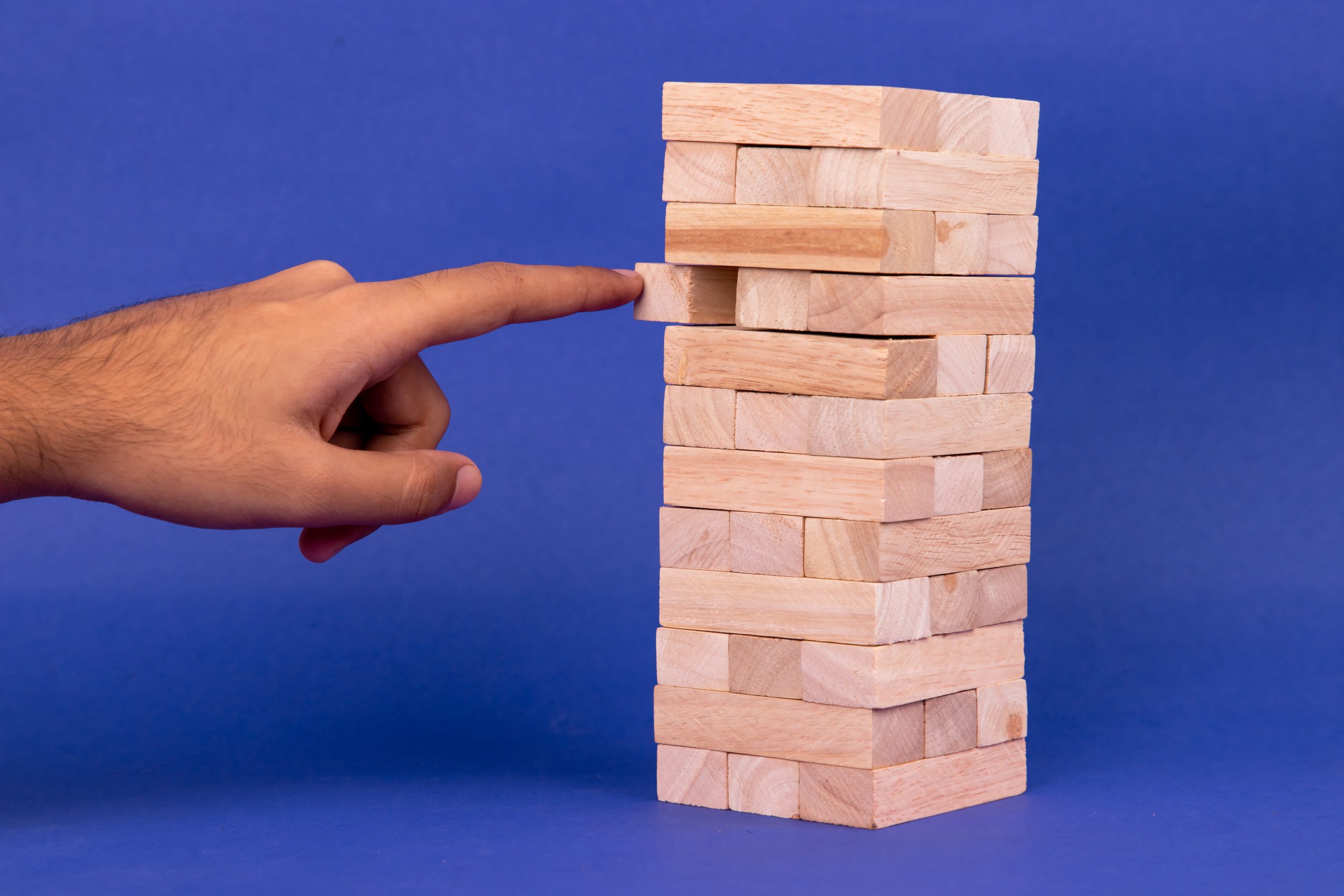 Hand sliding a piece of jenga