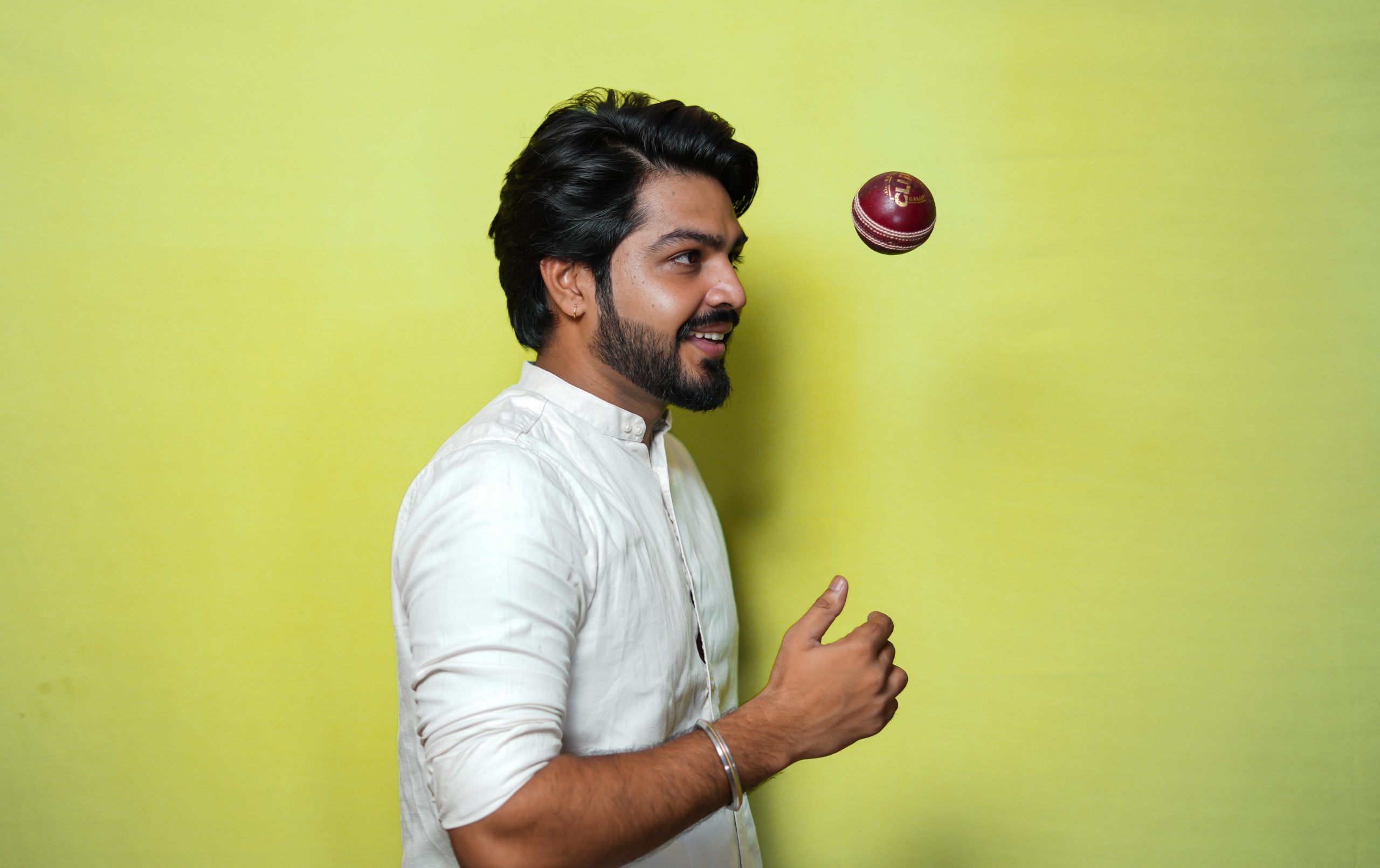 Handsome Man playing with cricket ball