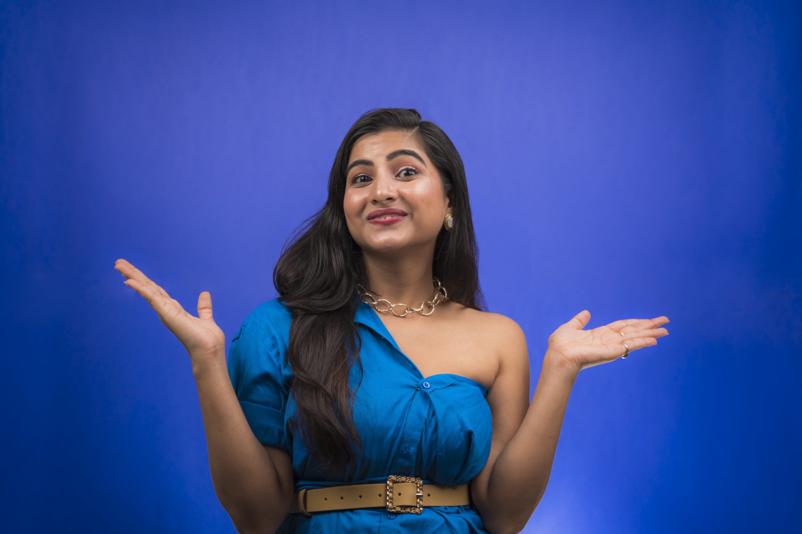 Happy indian girl pointing hands sideways