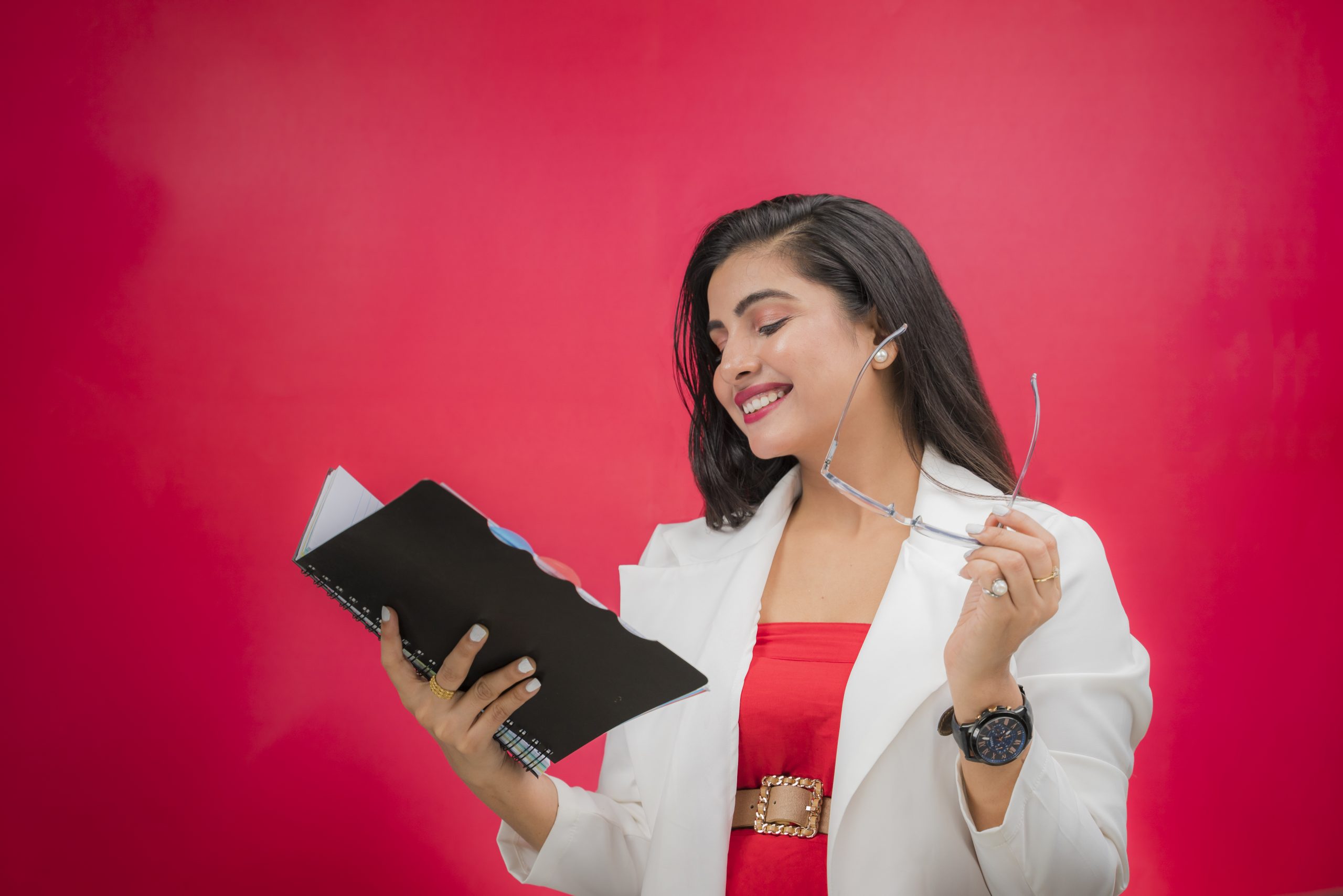 Happy working woman reading book