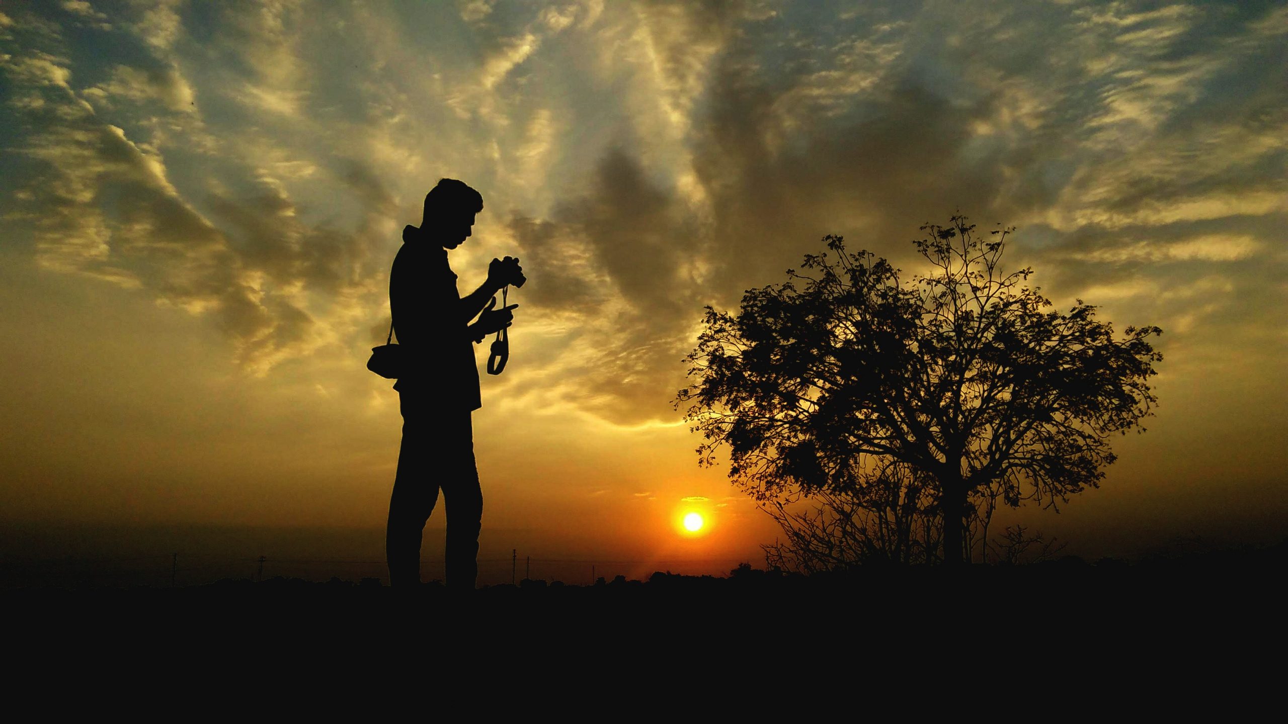 silhouette of a photographer during sunrise