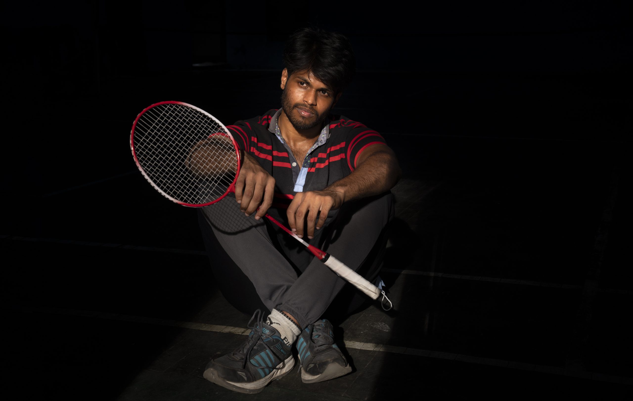 Indian male model holding badminton racket