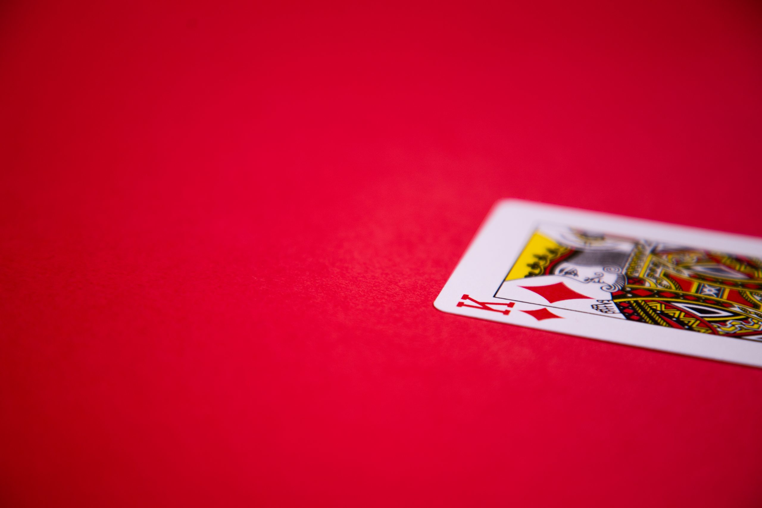 King of diamonds on red background