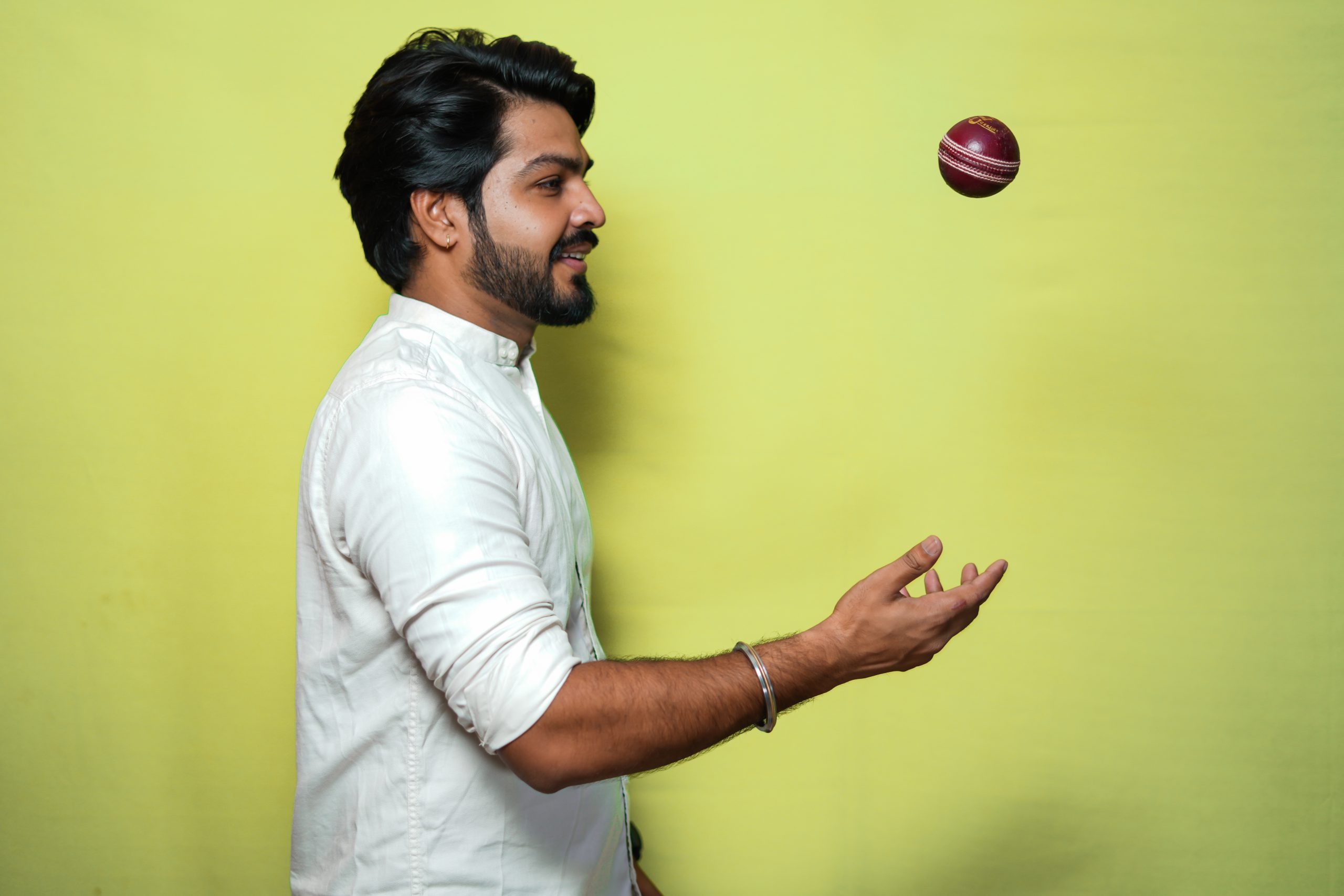 Male model tossing cricket ball