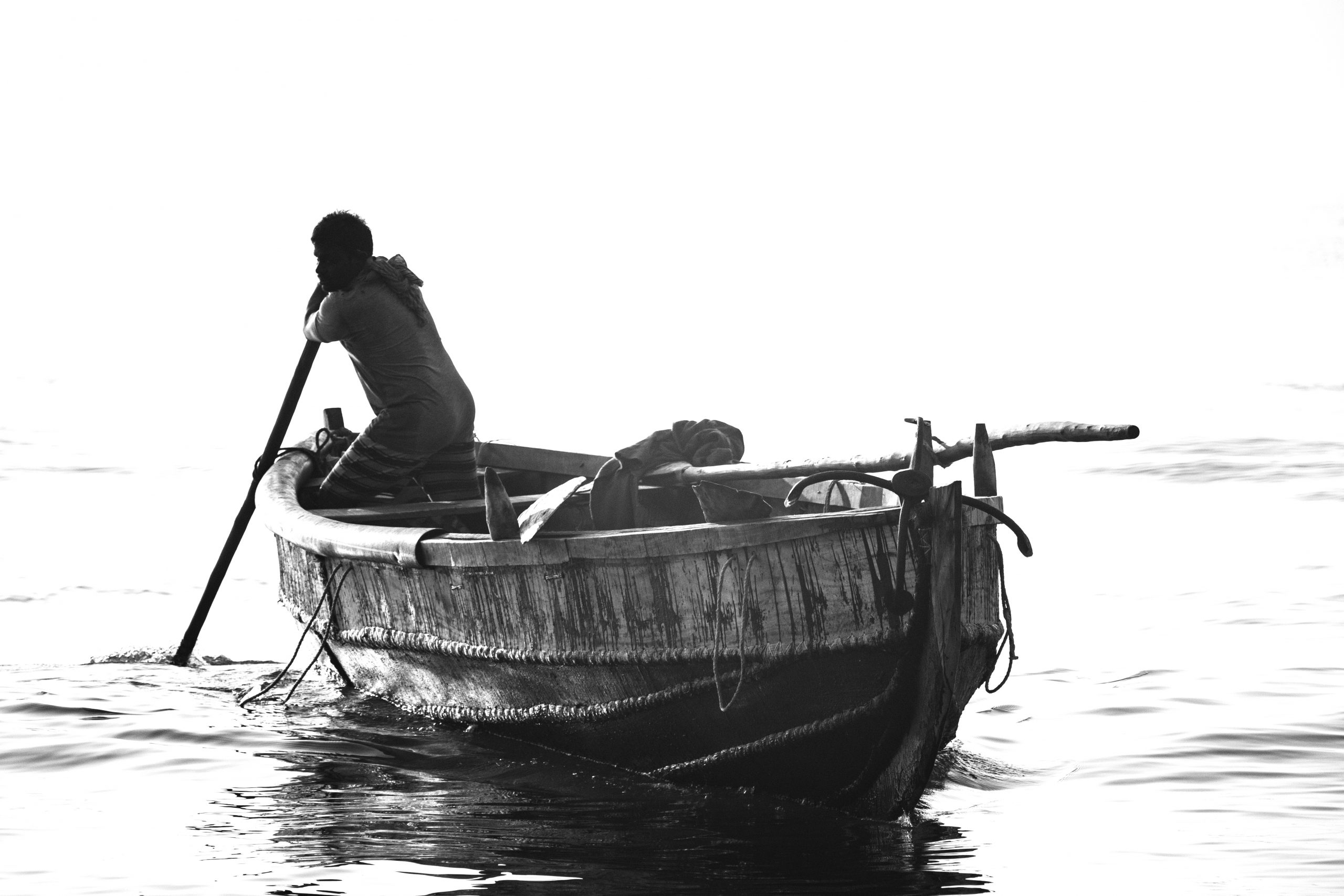 Monochrome of a fisherman rowing boat