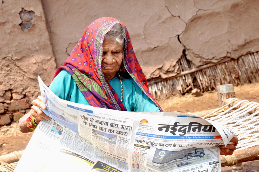 Old Woman Reading Newspaper