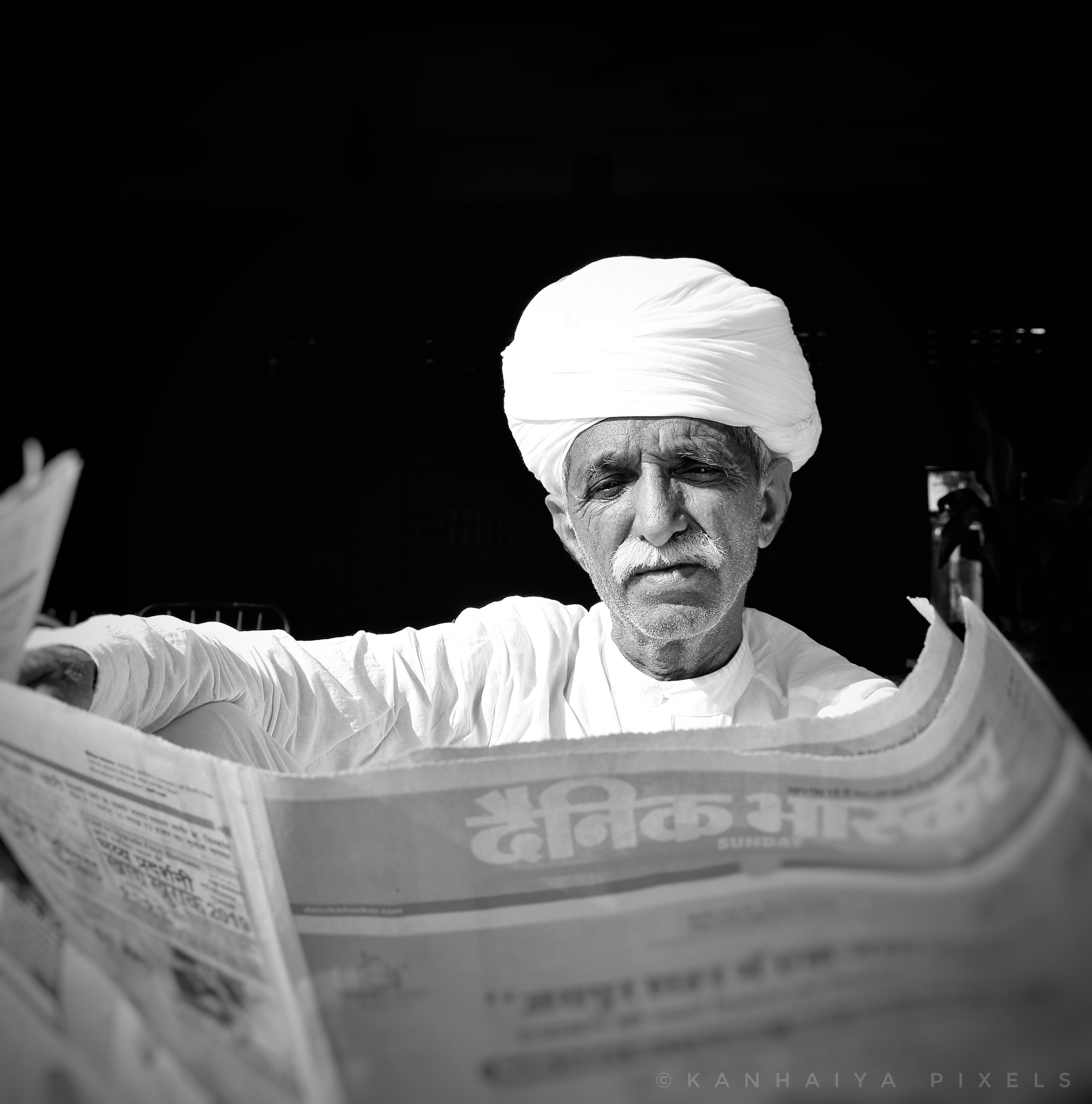 old man reading news paper