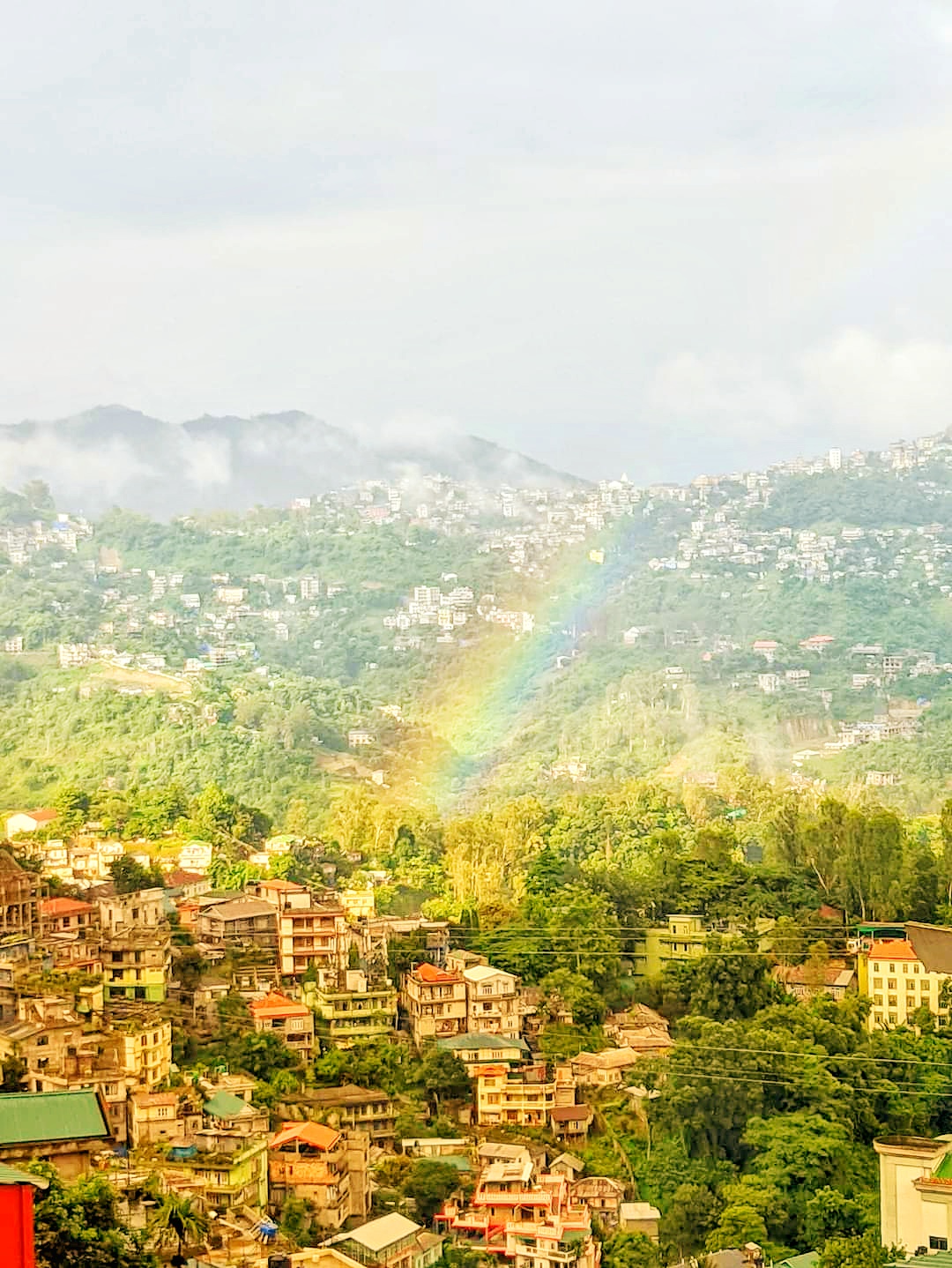 Rainbow over the city and mountains