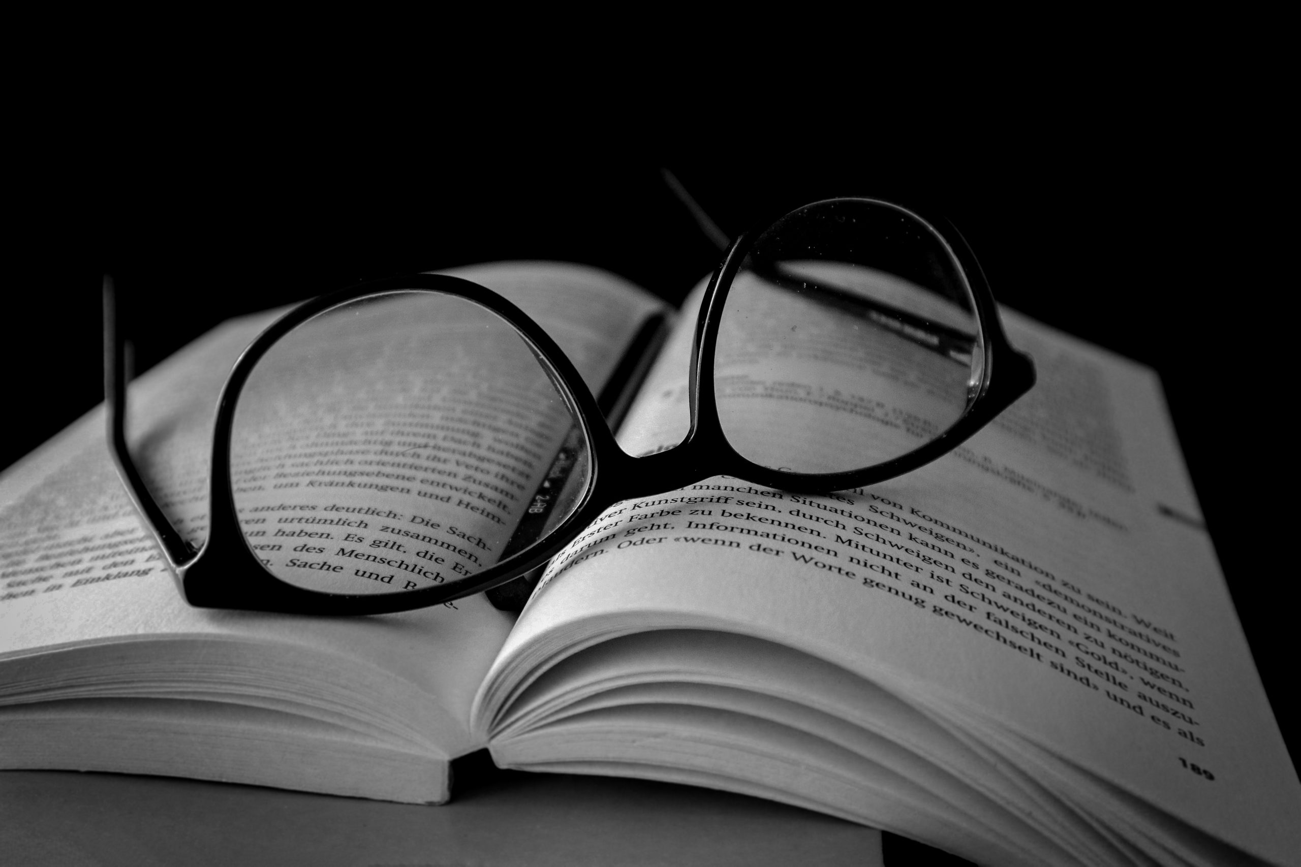 Reader's Book and Eyeglasses on Focus
