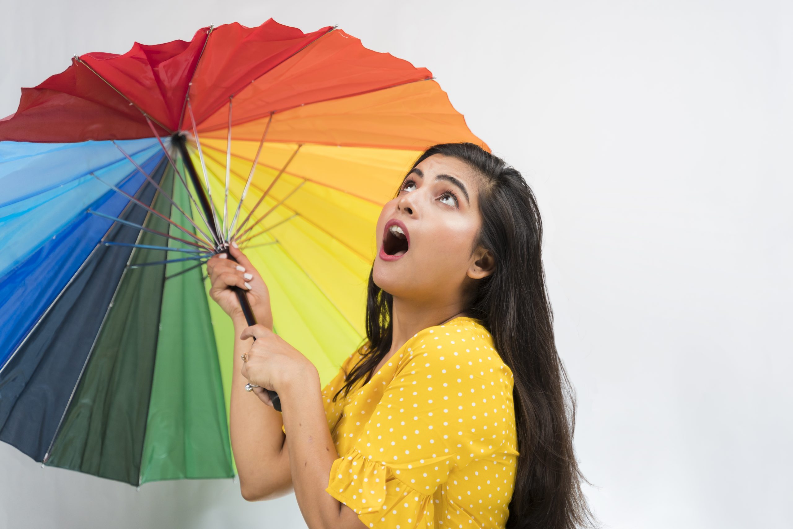 Shocked indian girl with colorful umbrella