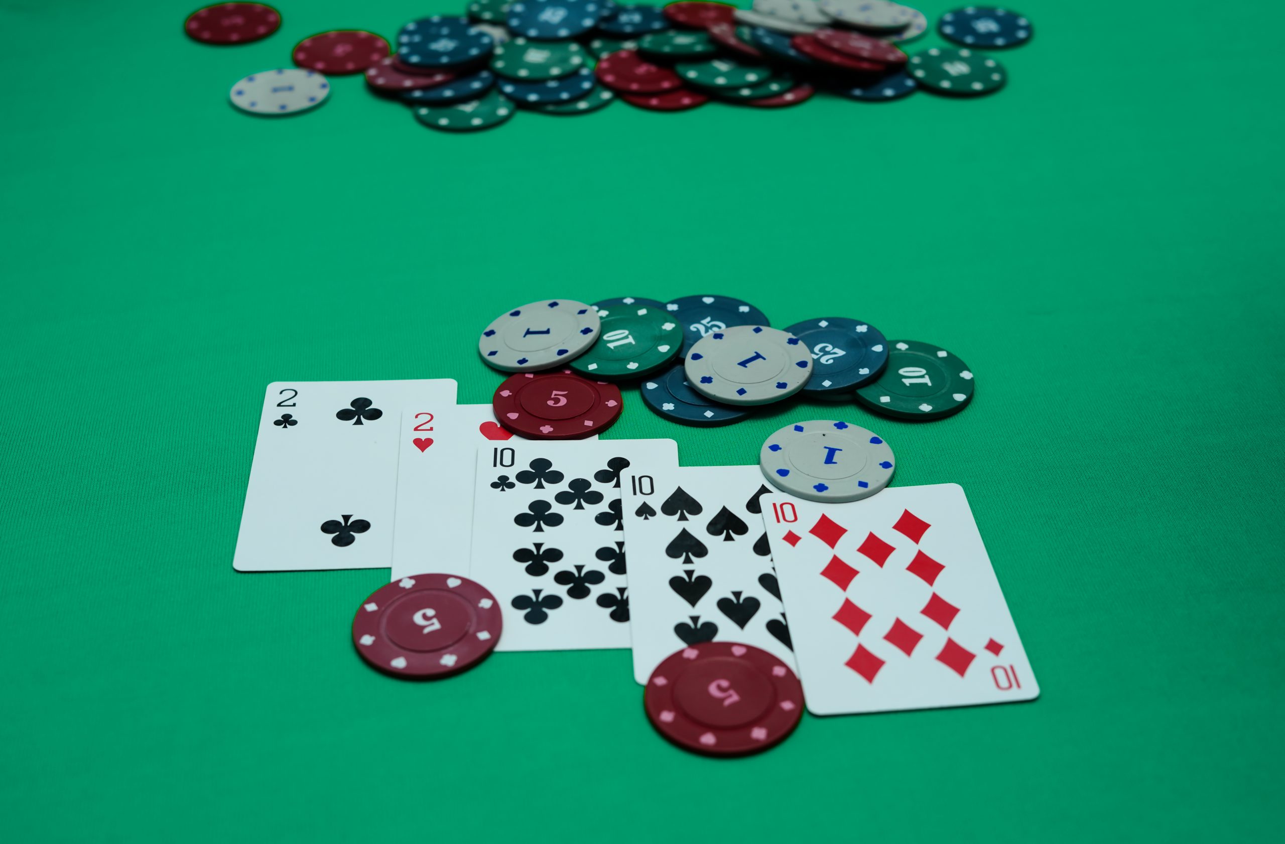 Poker studs and cards on a table.