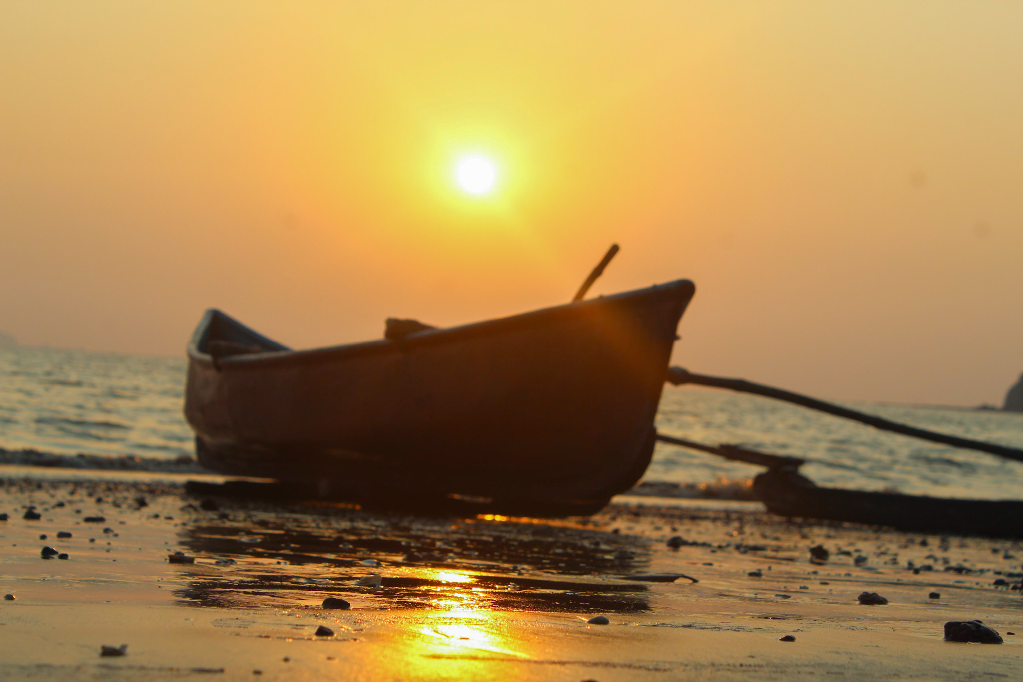 Sunset view of a boat on the beach