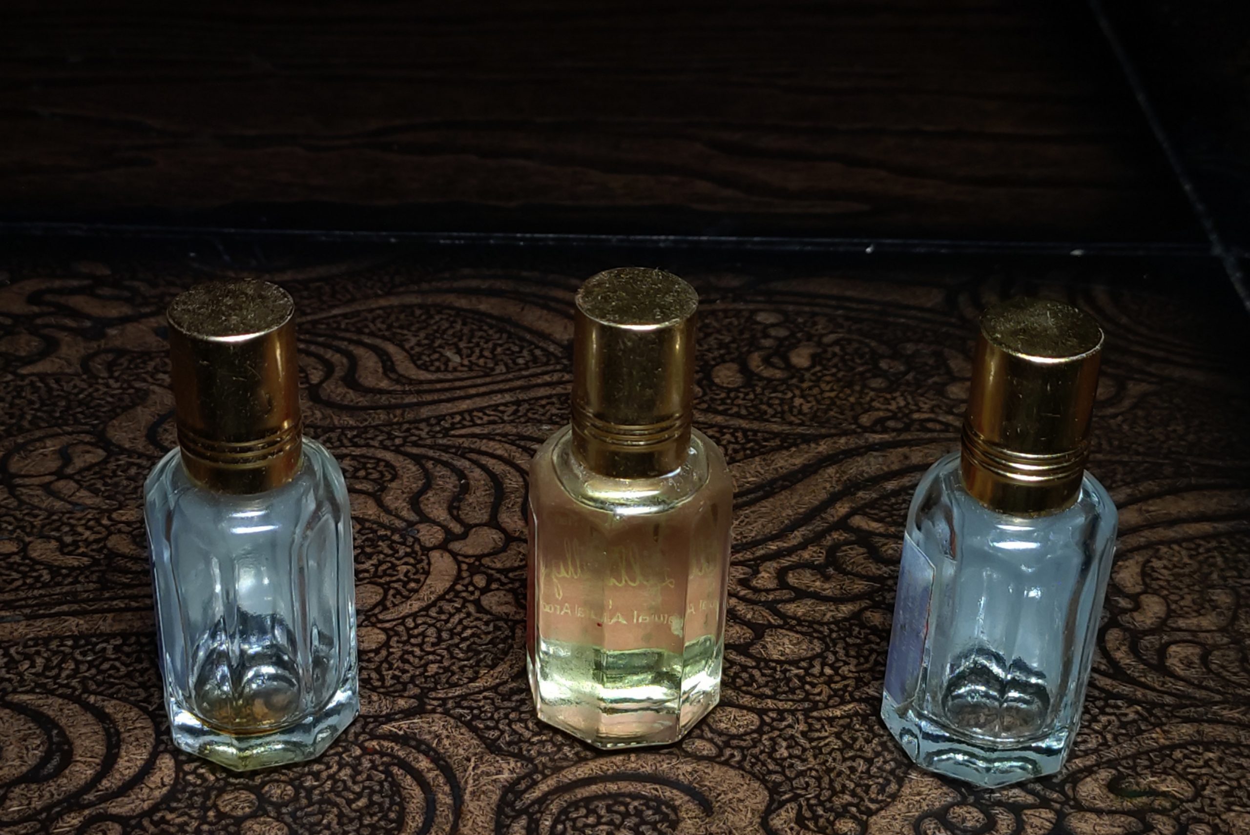 Three perfume bottles on a table