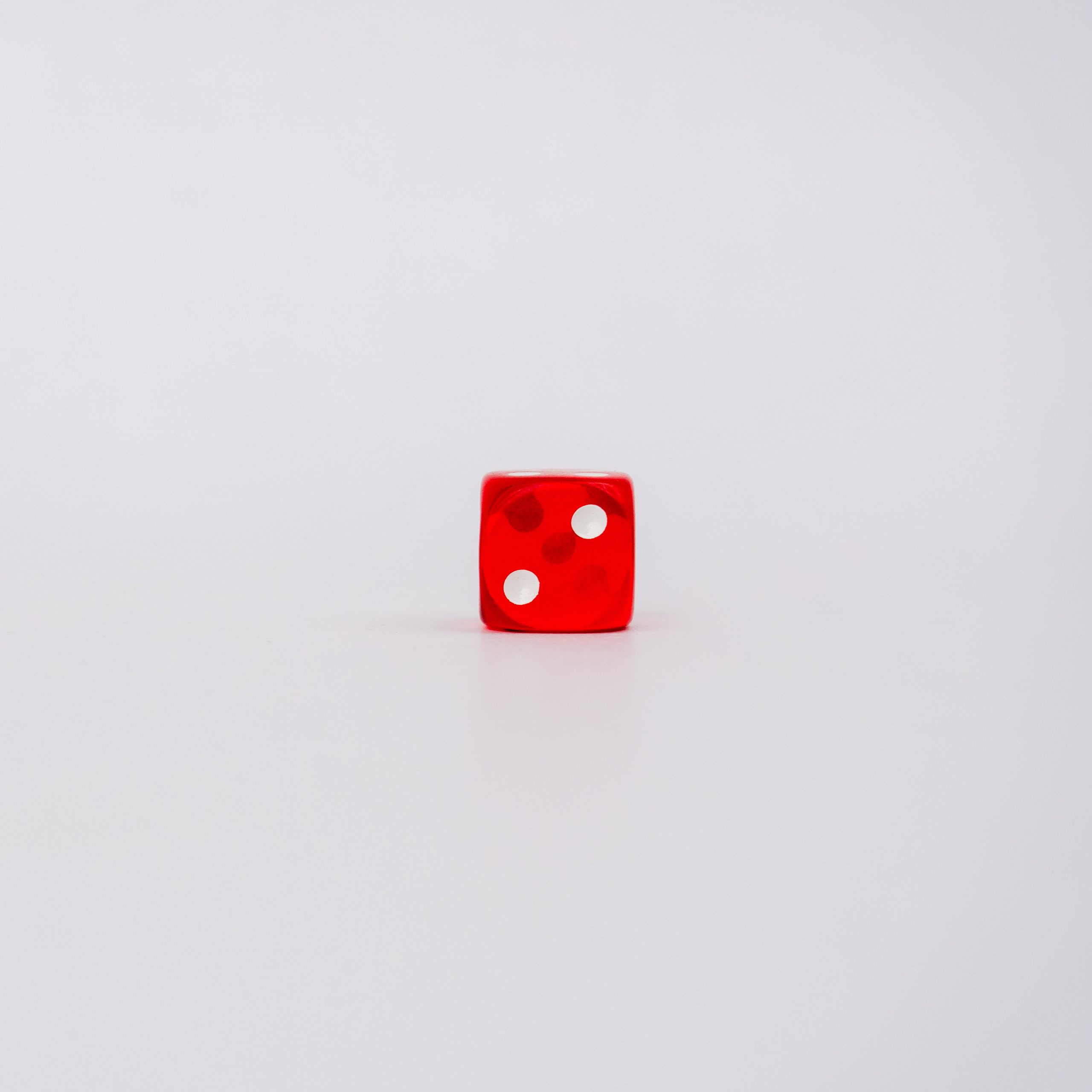 Two on red dice on white background