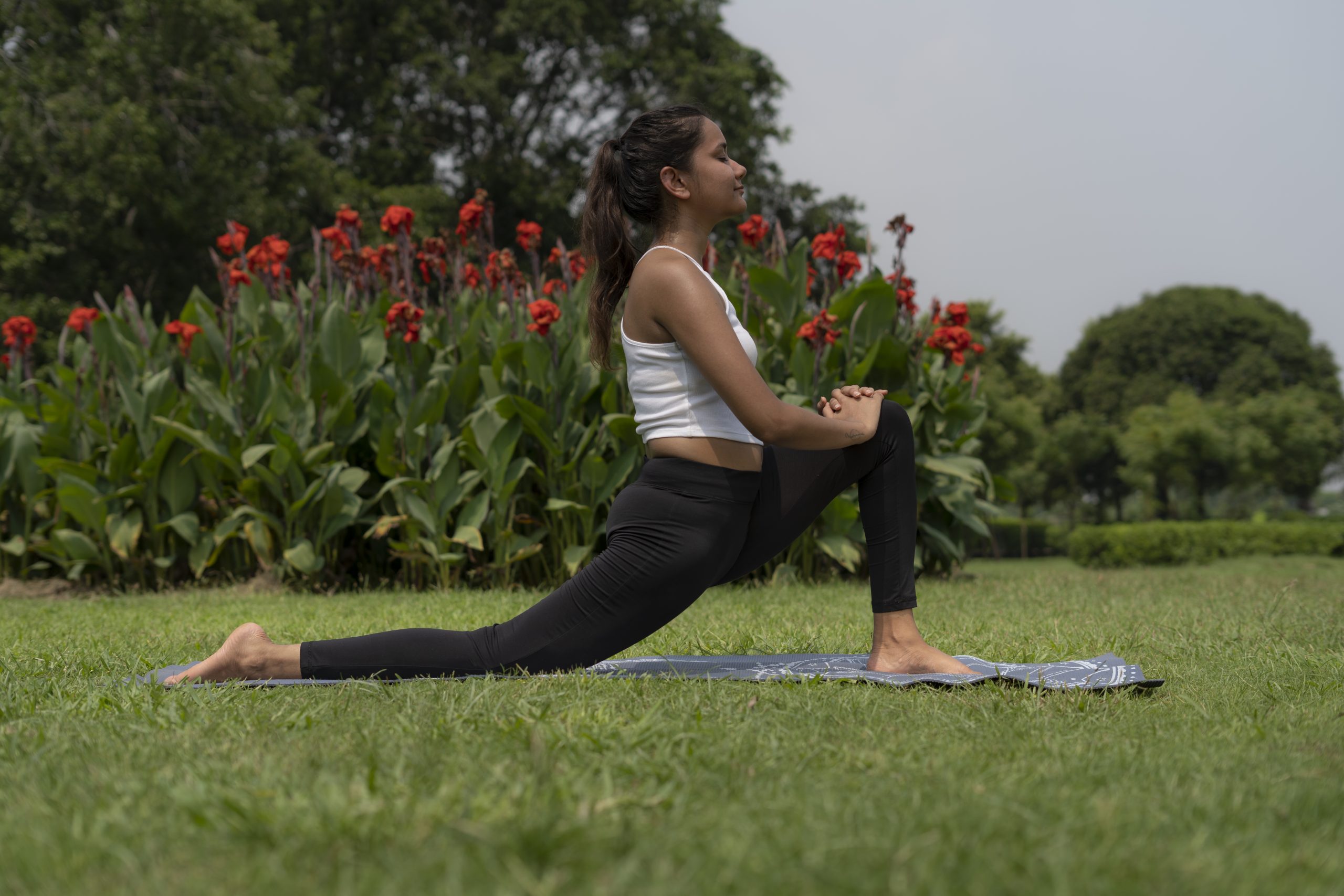 Yoga girl stretching in park