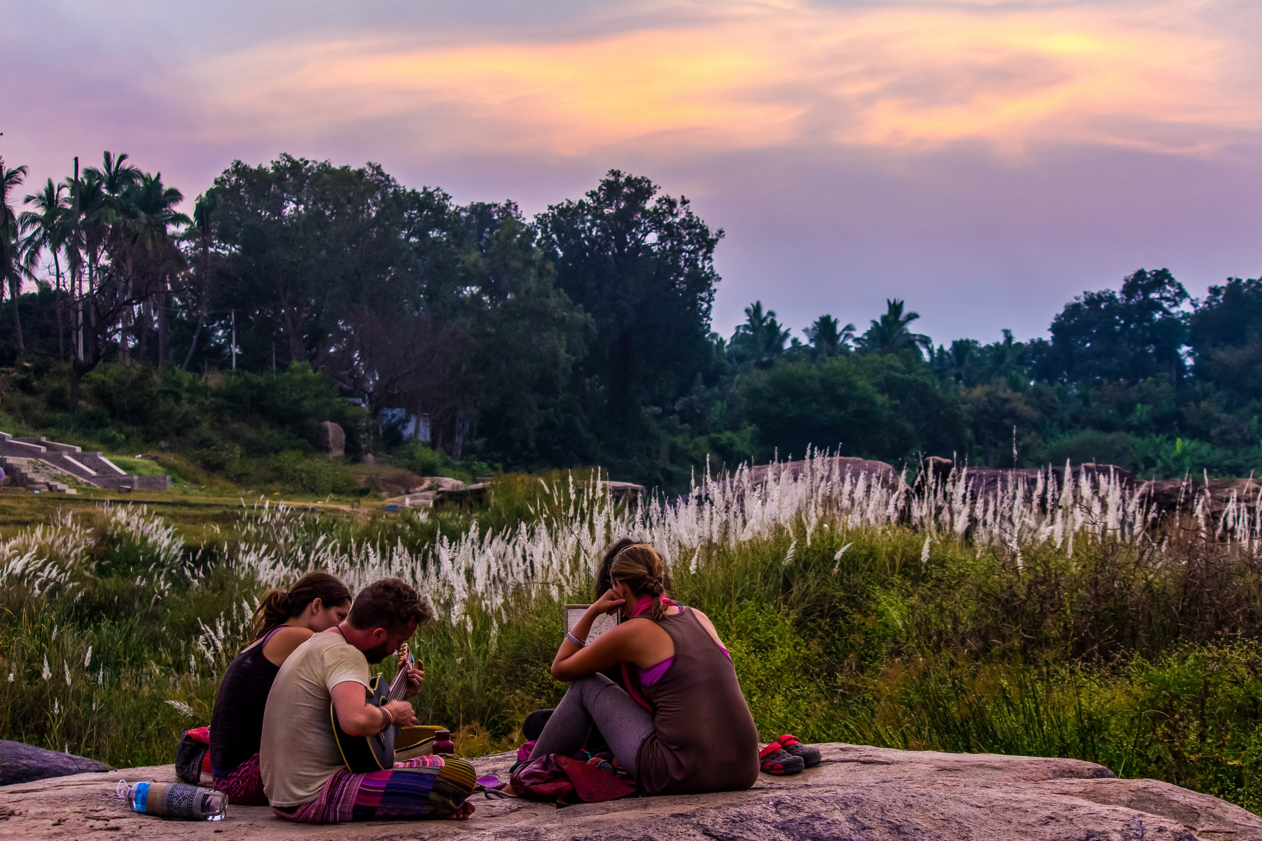 Youngsters sitting on a rock in Hampi