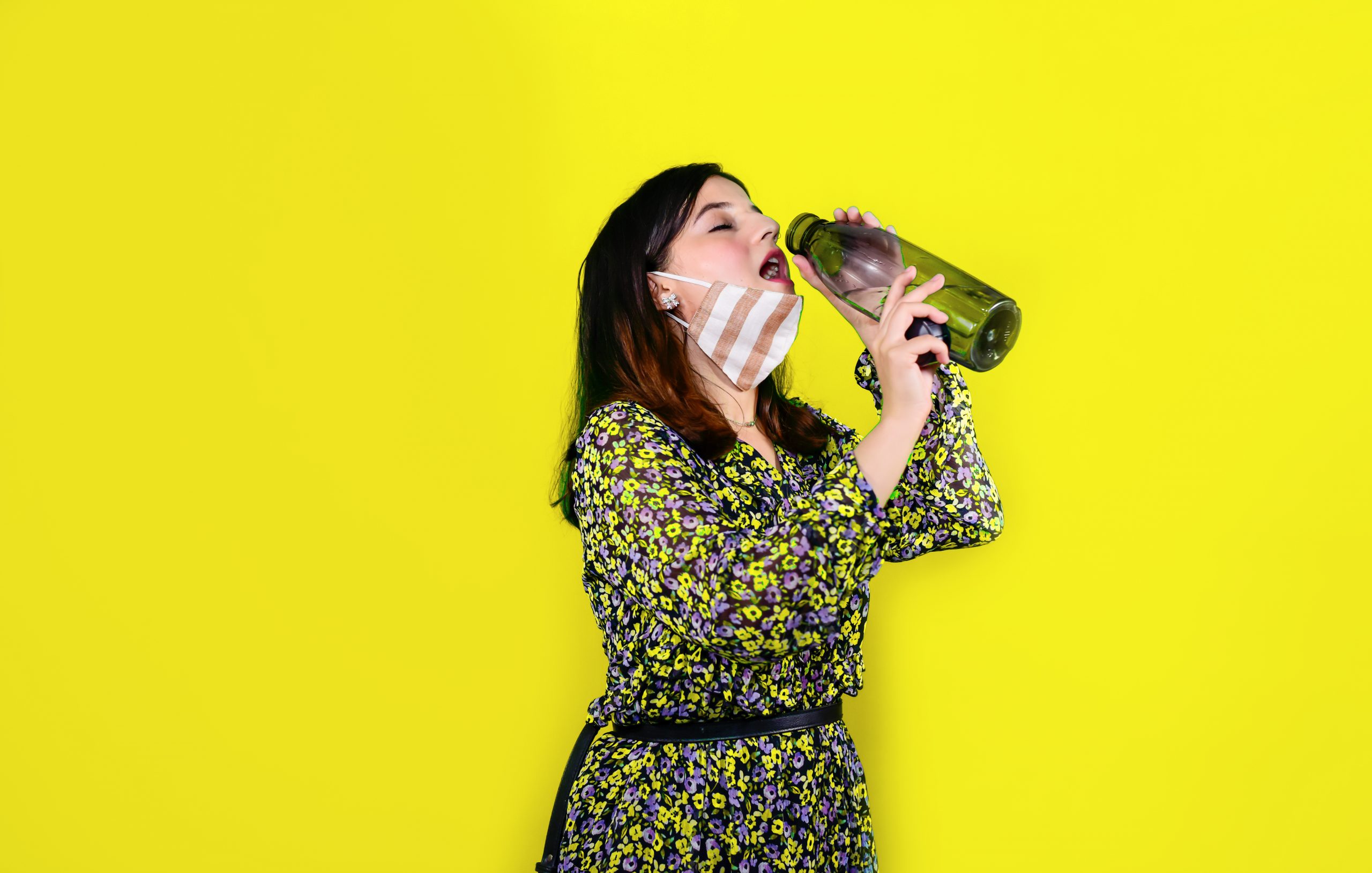 A Girl wearing Mask Drinking water