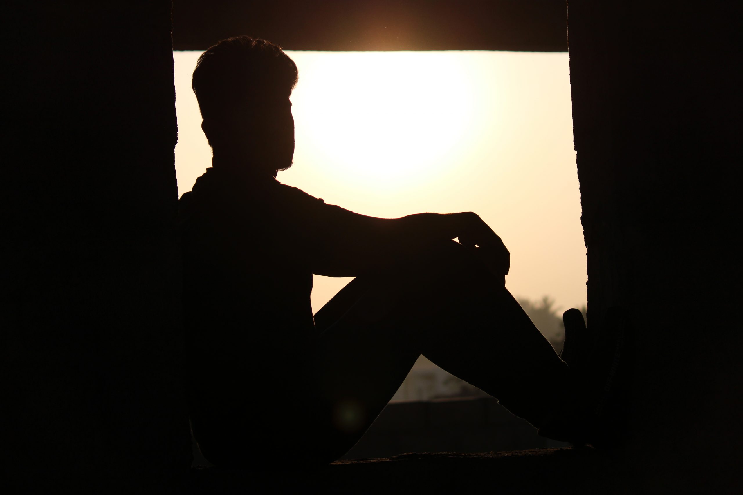 A boy sitting on window