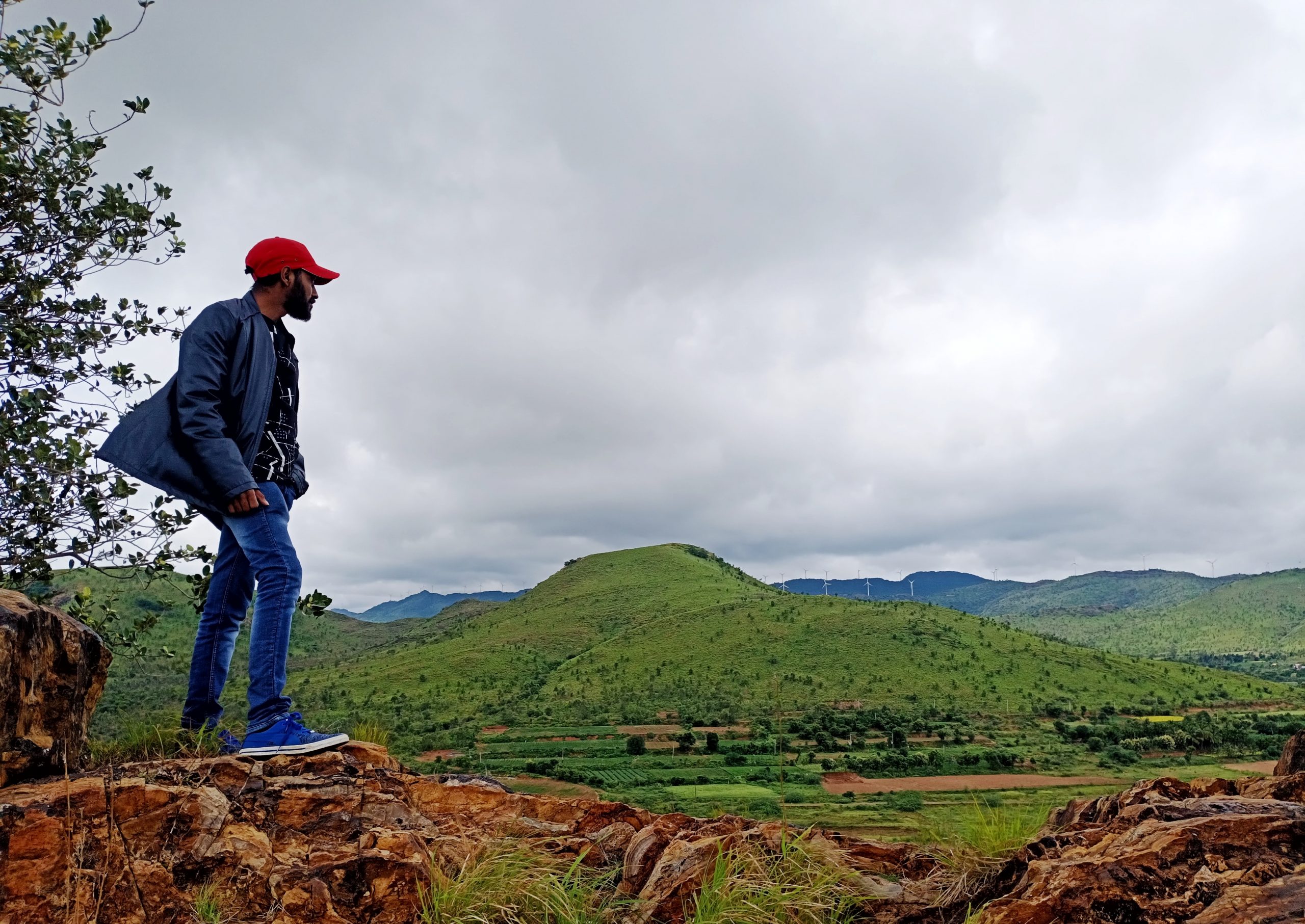 A boy standing on a mountain edge