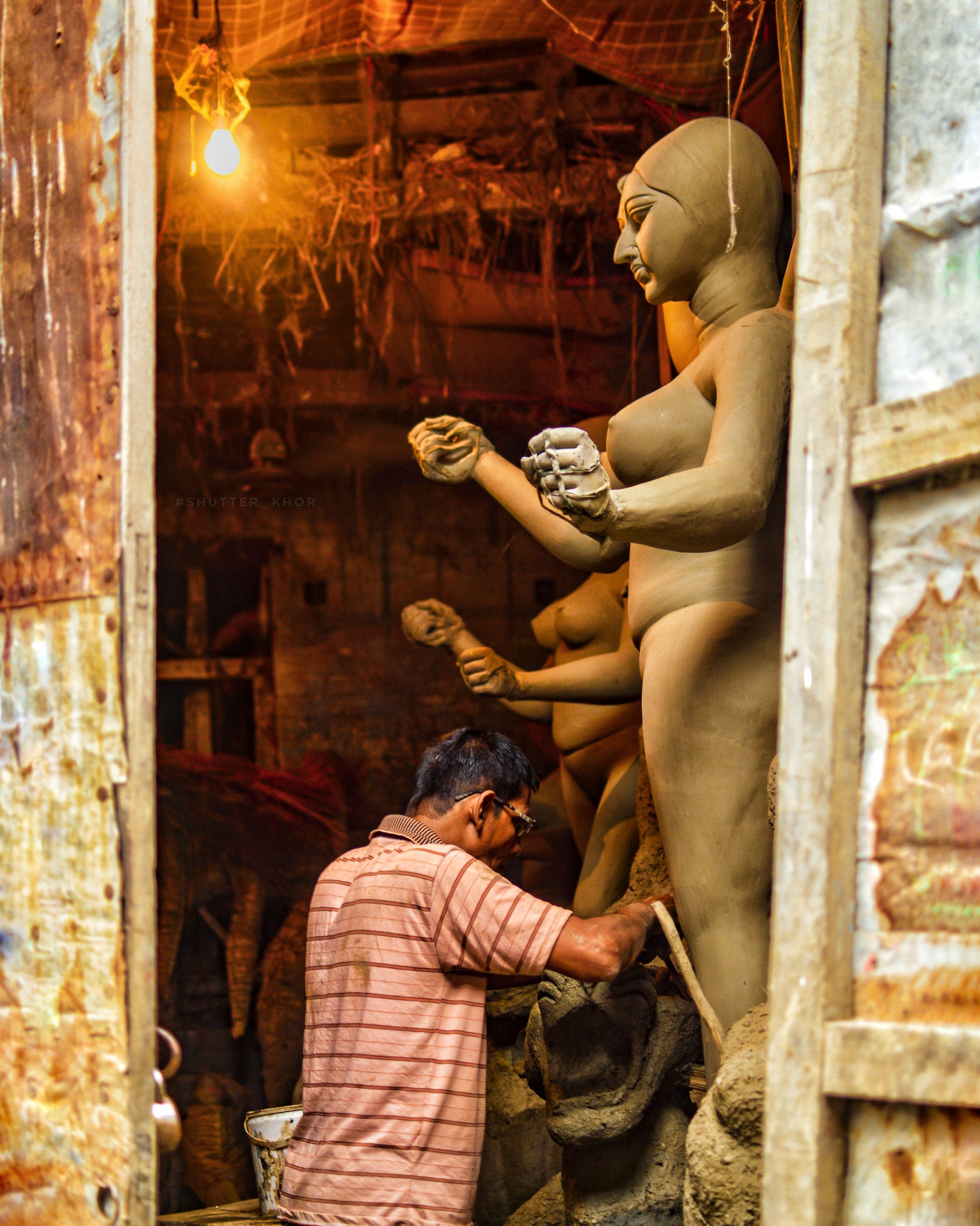 A craftsman working on statues