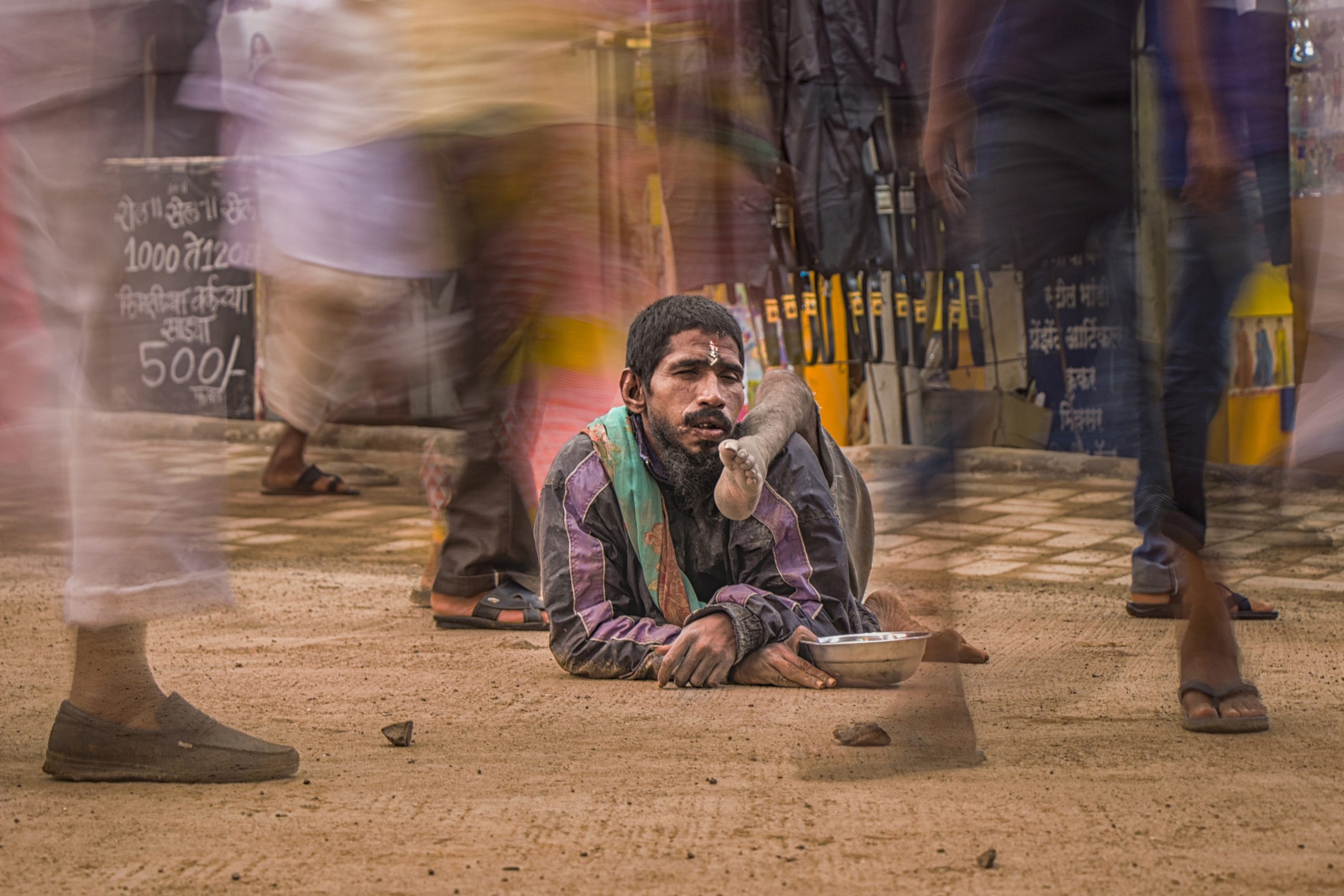 A disabled beggar in a market