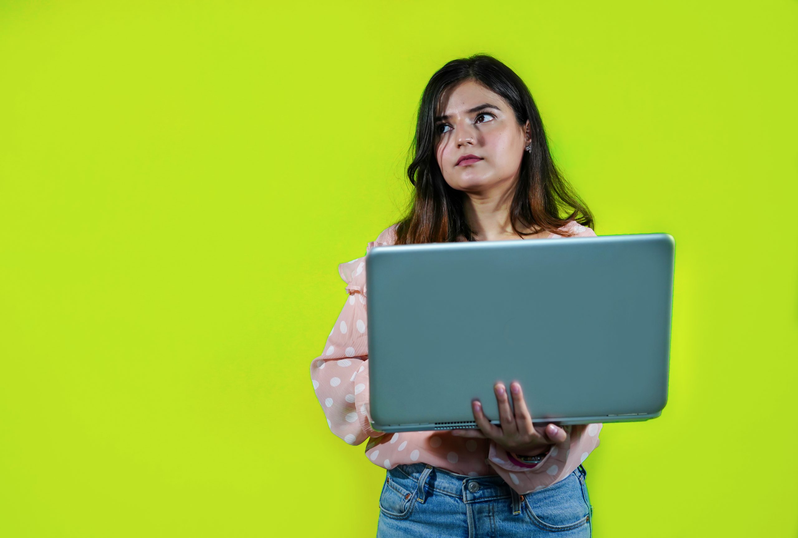 A girl holding a laptop in hands