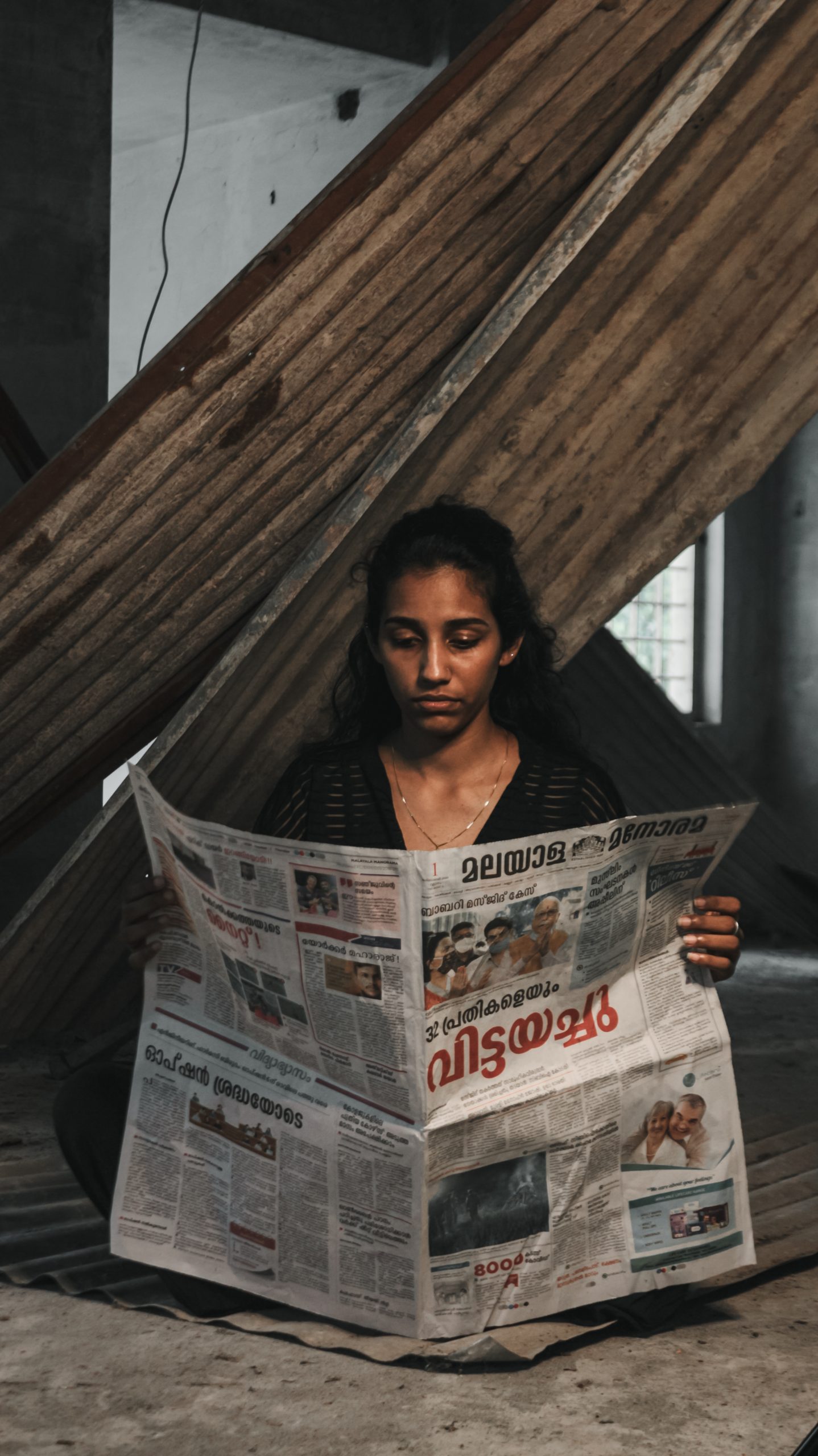A girl reading newspaper