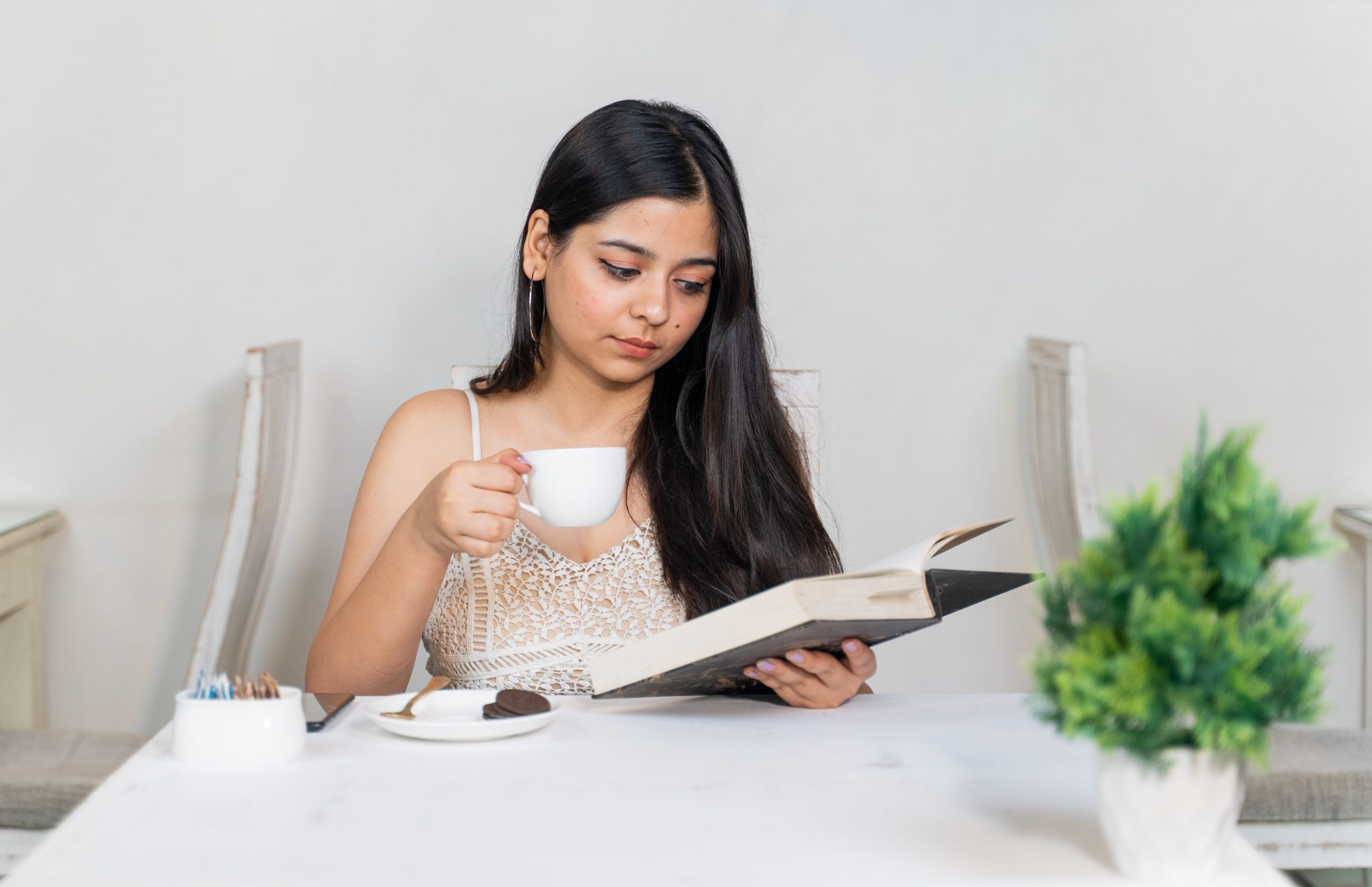 A girl taking tea while studying